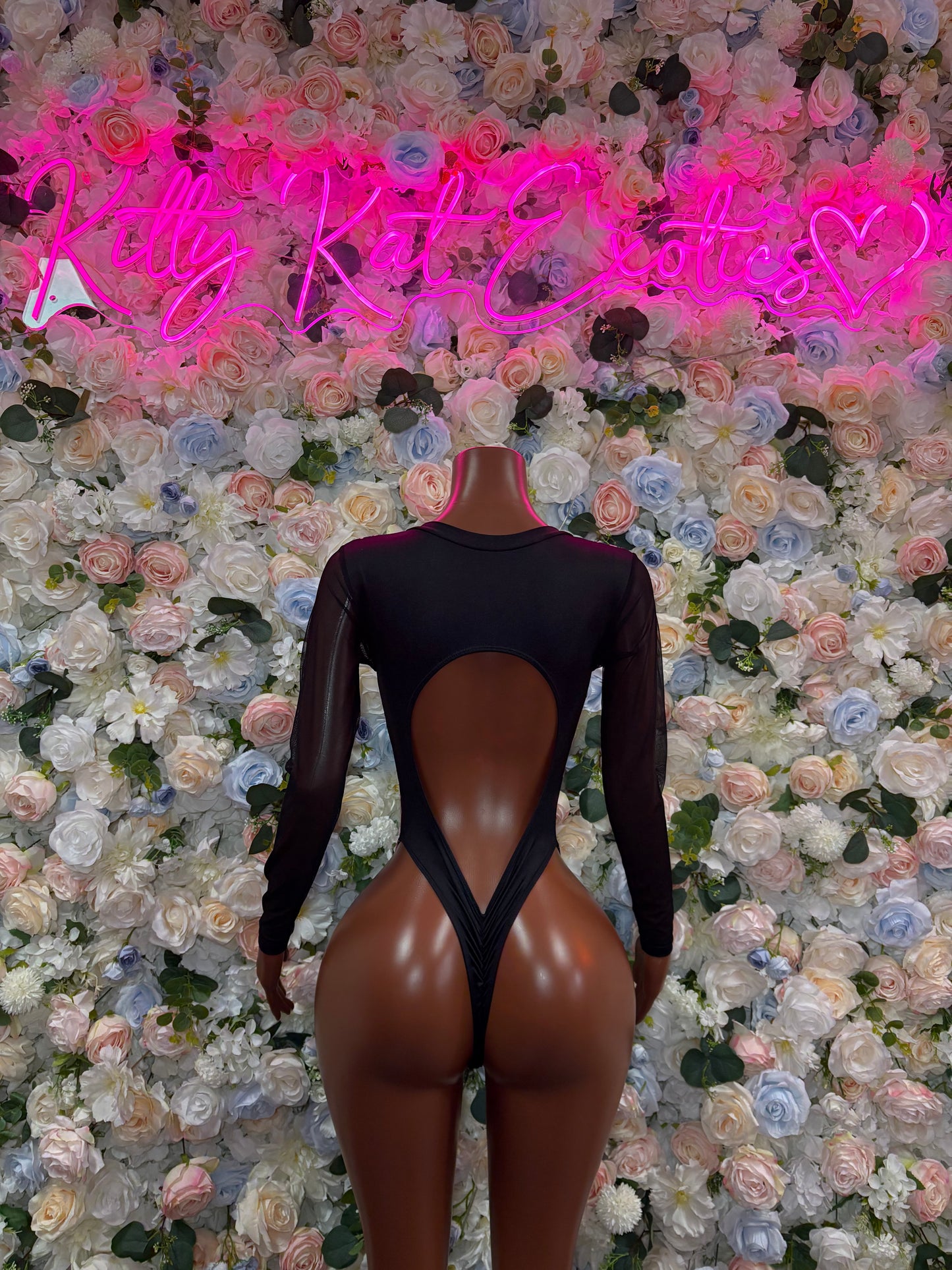 Black long-sleeve bodysuit with neon pink lightning bolt back print and open back