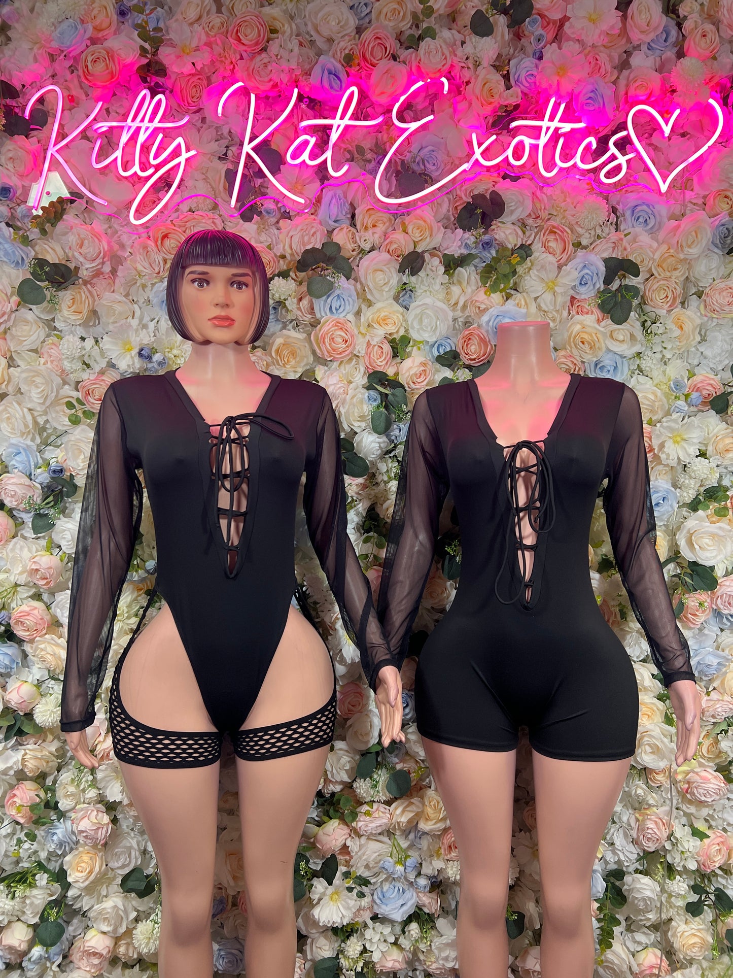 Black long-sleeve lace-up bodysuit with sheer panels and cutout front, matching garter shorts