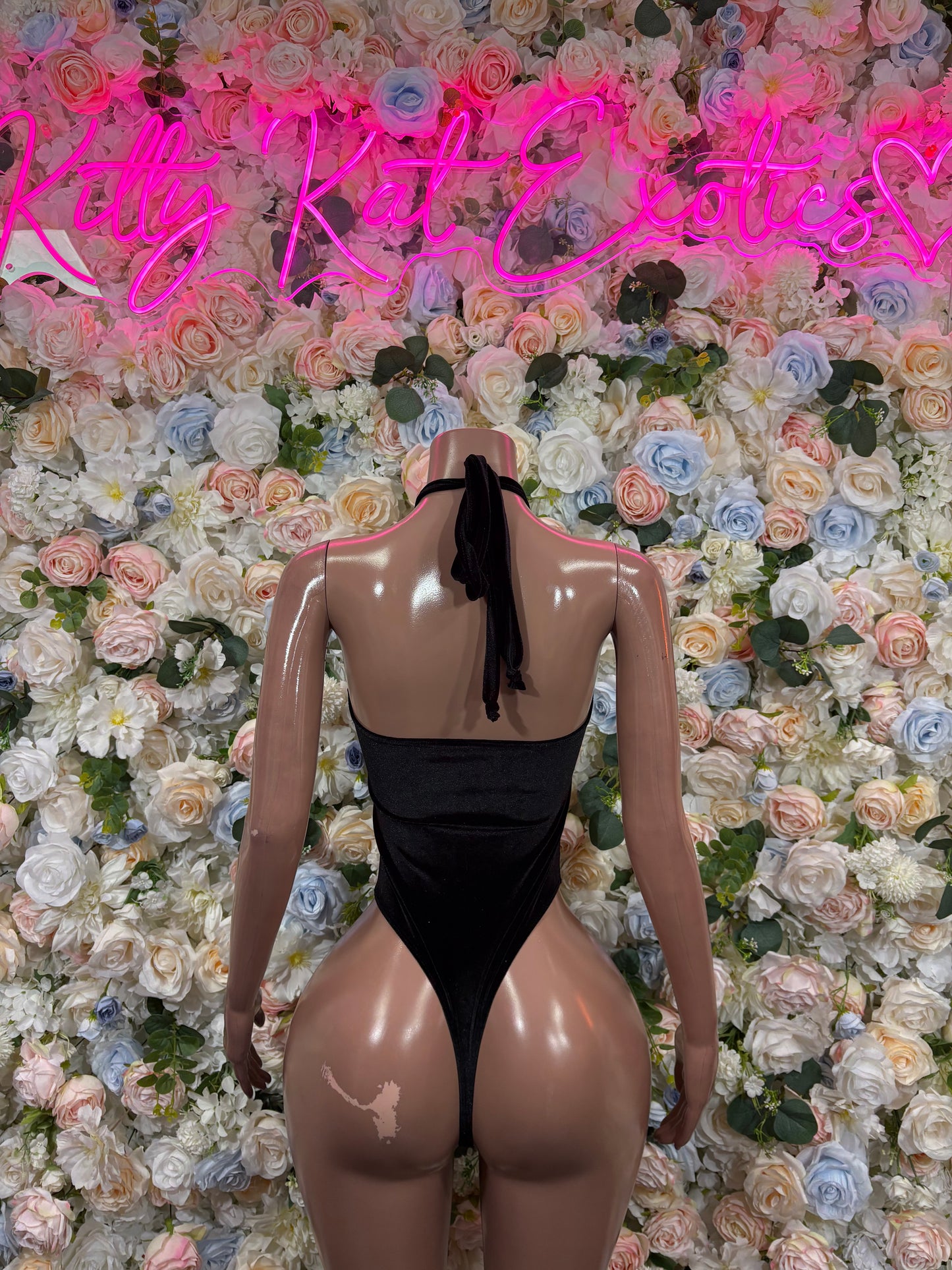 Black velvet one-piece bodysuit with open back and thong bottom