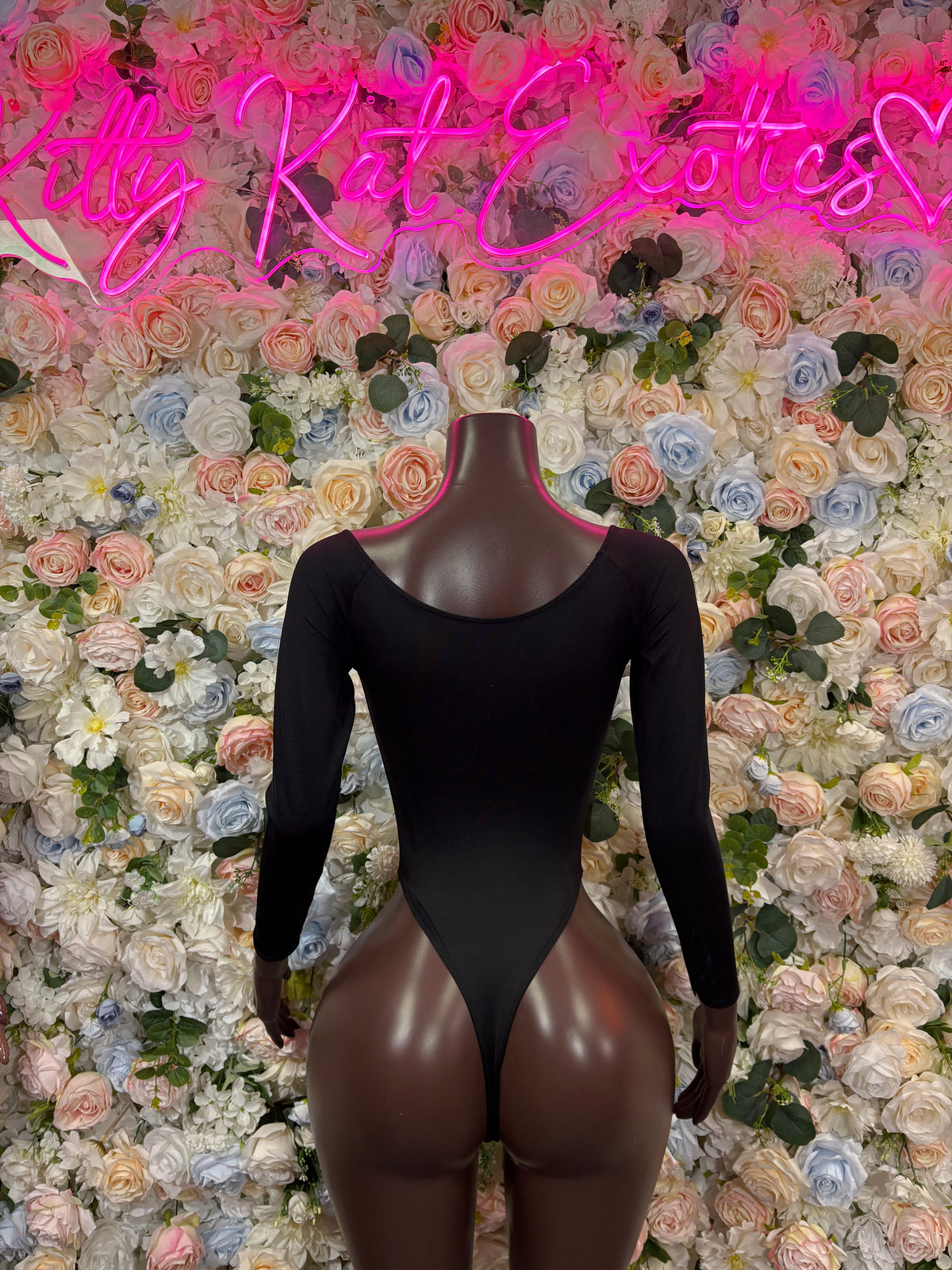 Black long-sleeve bodysuit with deep scoop neckline and high-cut bottom
