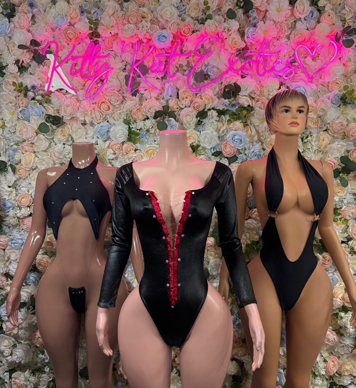 Black long-sleeve bodysuit with deep V neckline and red-trim front detail.