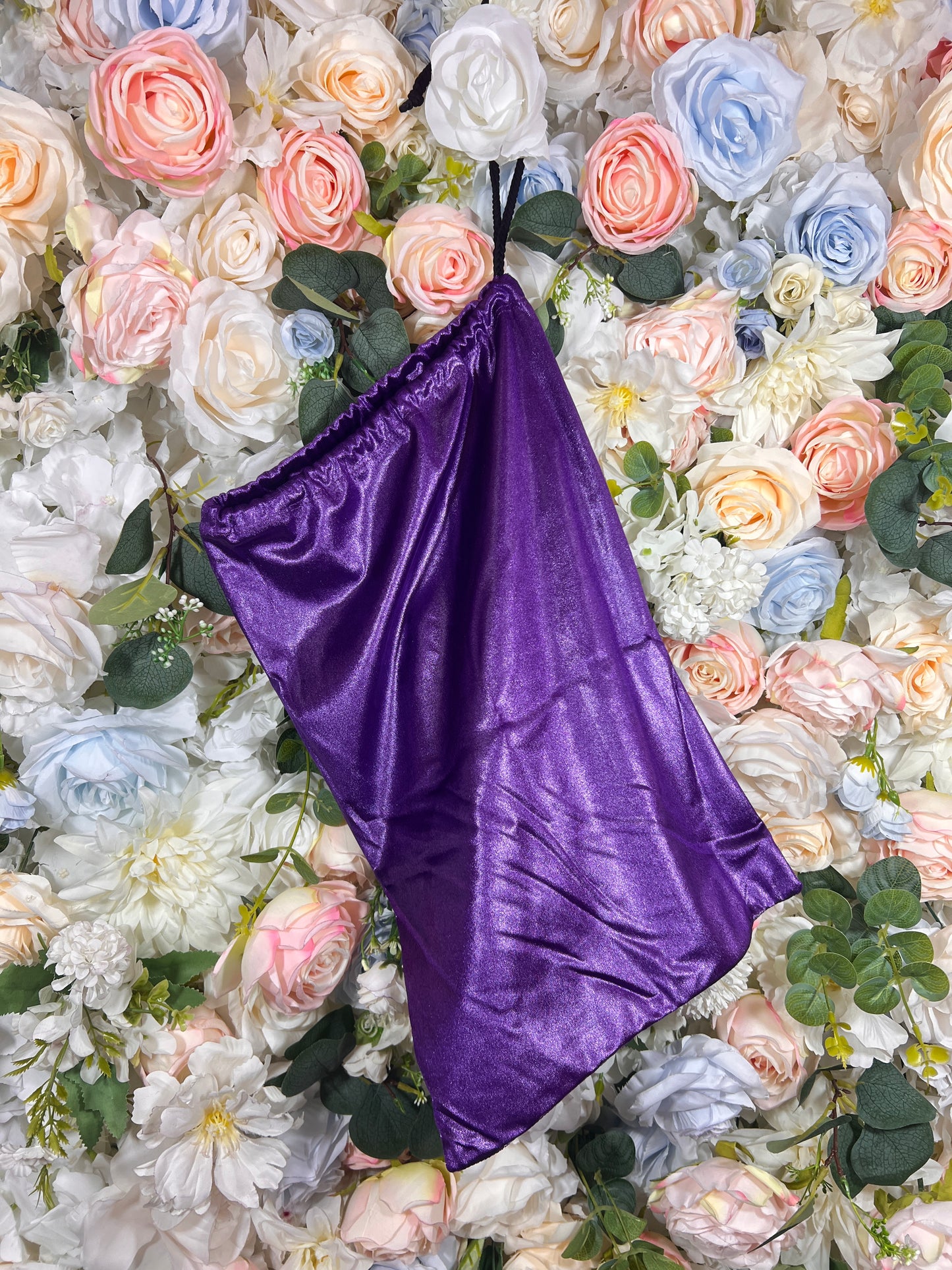 Purple velvet pouch bag with black handle loops and gathered top