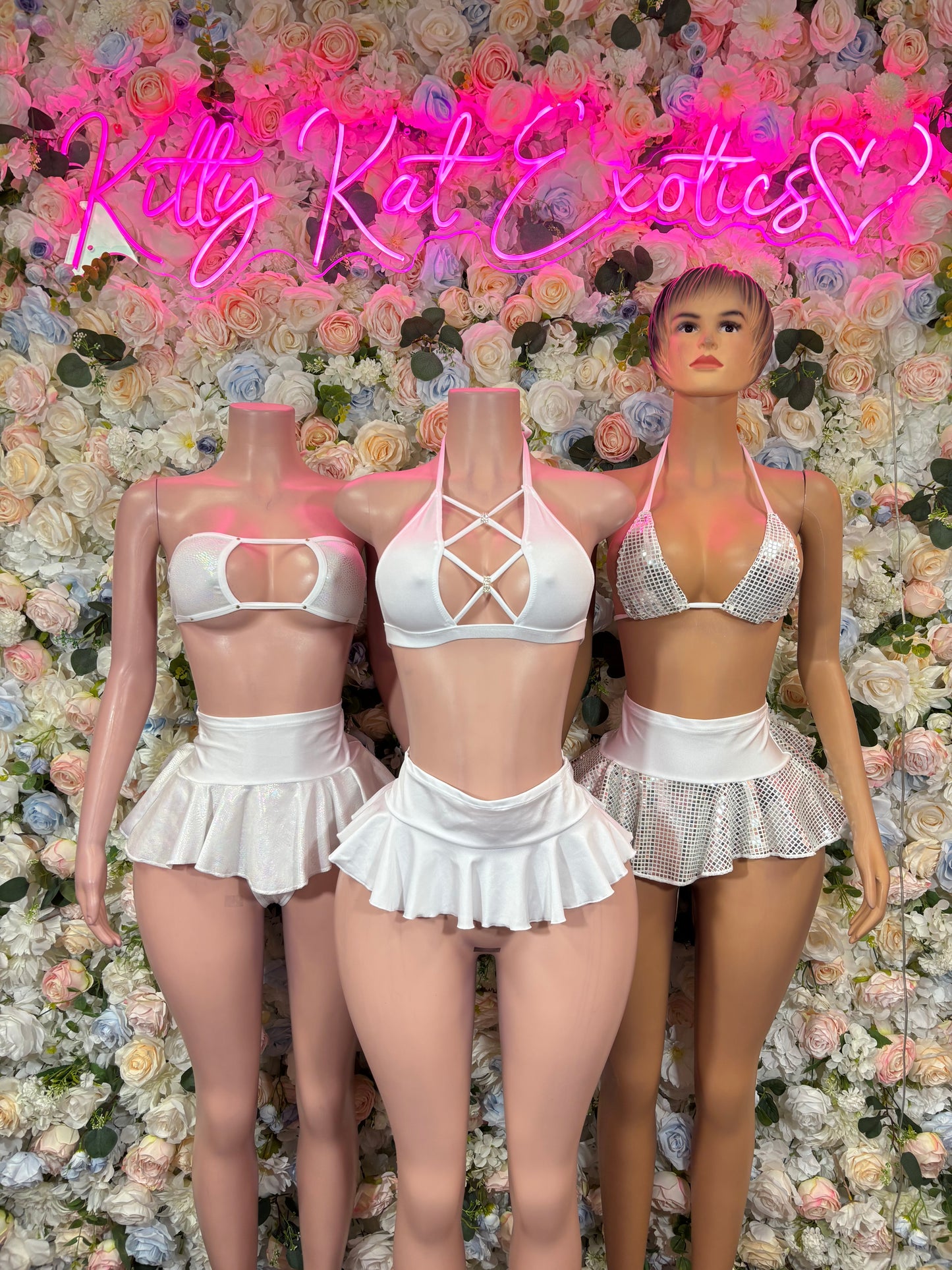 White two-piece dancewear set with crisscross strap crop top and ruffled mini skirt