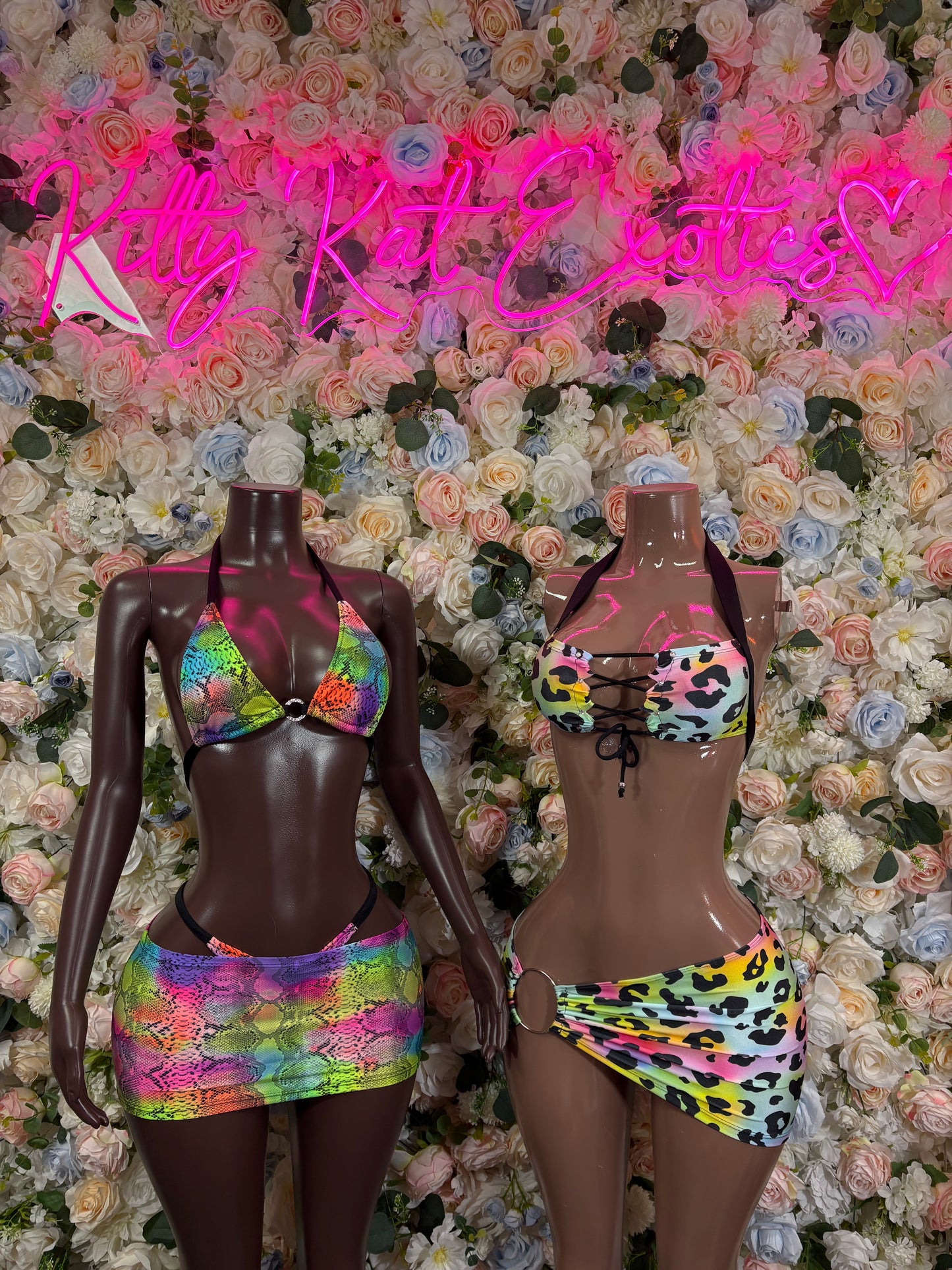 Animal print rainbow two-piece rave set on two mannequins: bra top and mini skirt