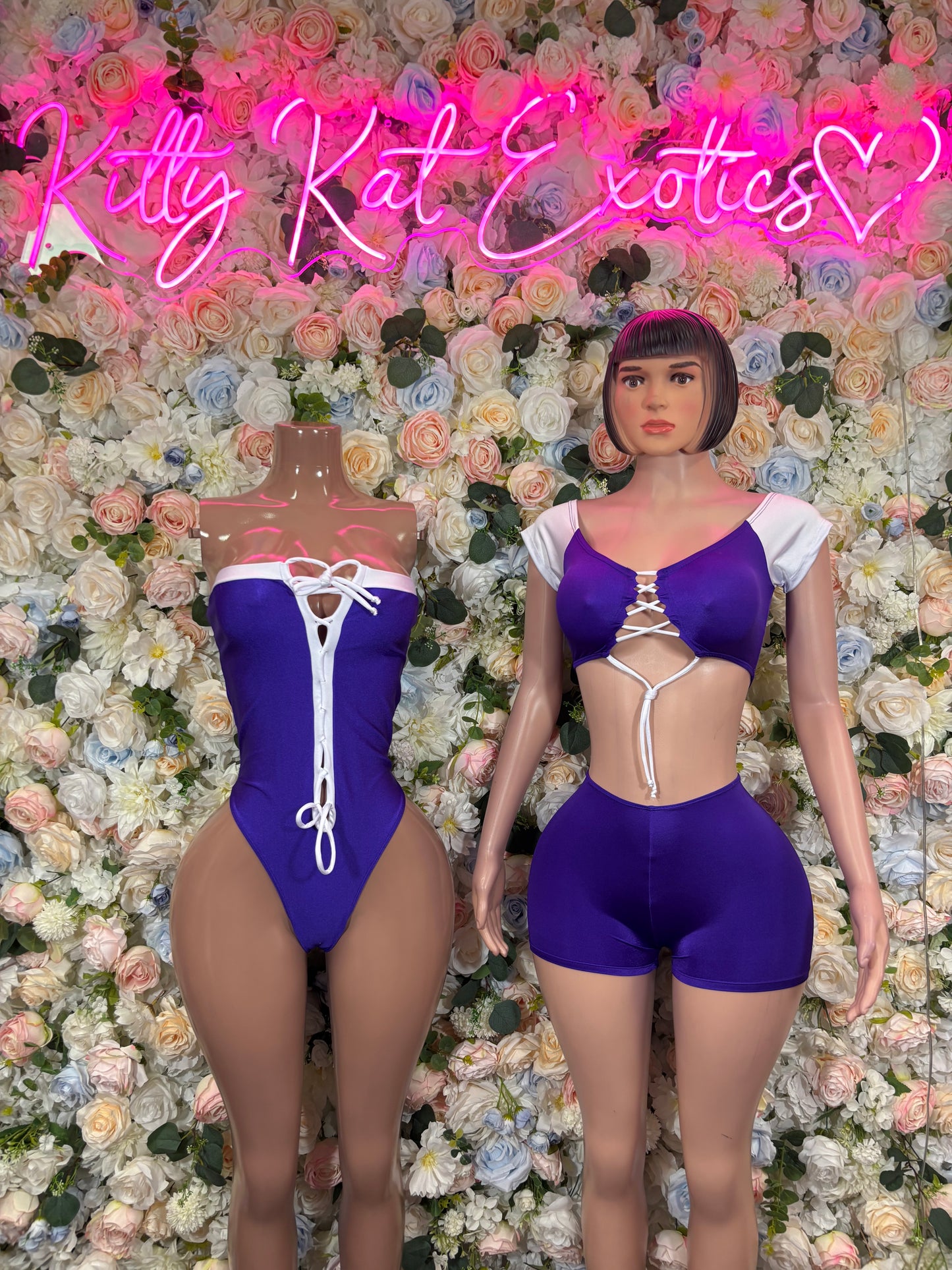Purple satin-style bodysuit costume with white lace-up front and cutout waist