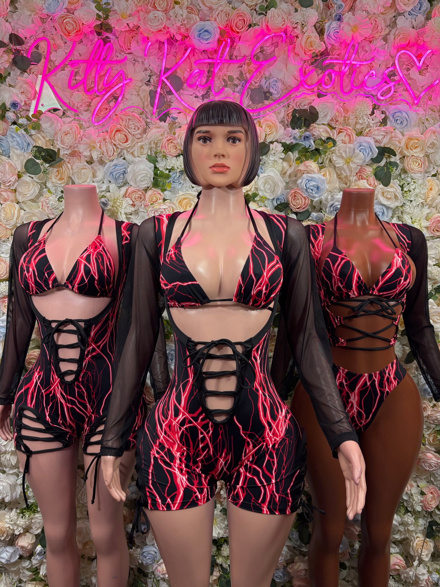 Red electric-line one-piece bodysuit with long sleeves, front cutouts, and lace-up straps
