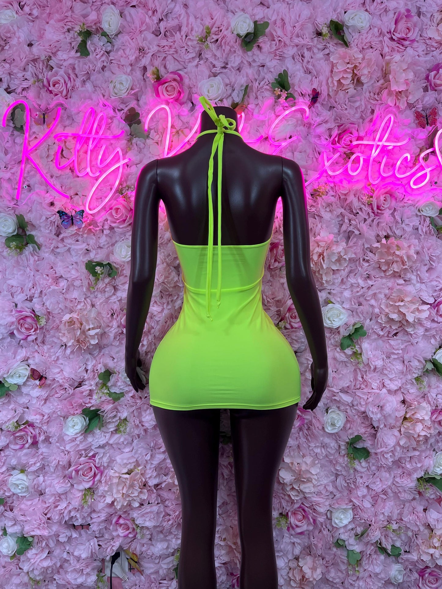 Neon green backless mini dress with black mesh panels and crisscross straps