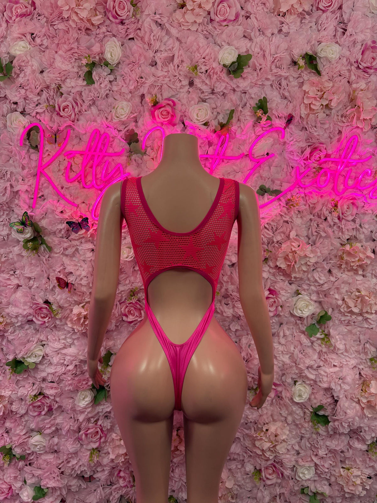 Pink fishnet bodysuit with open back and high-leg cutouts
