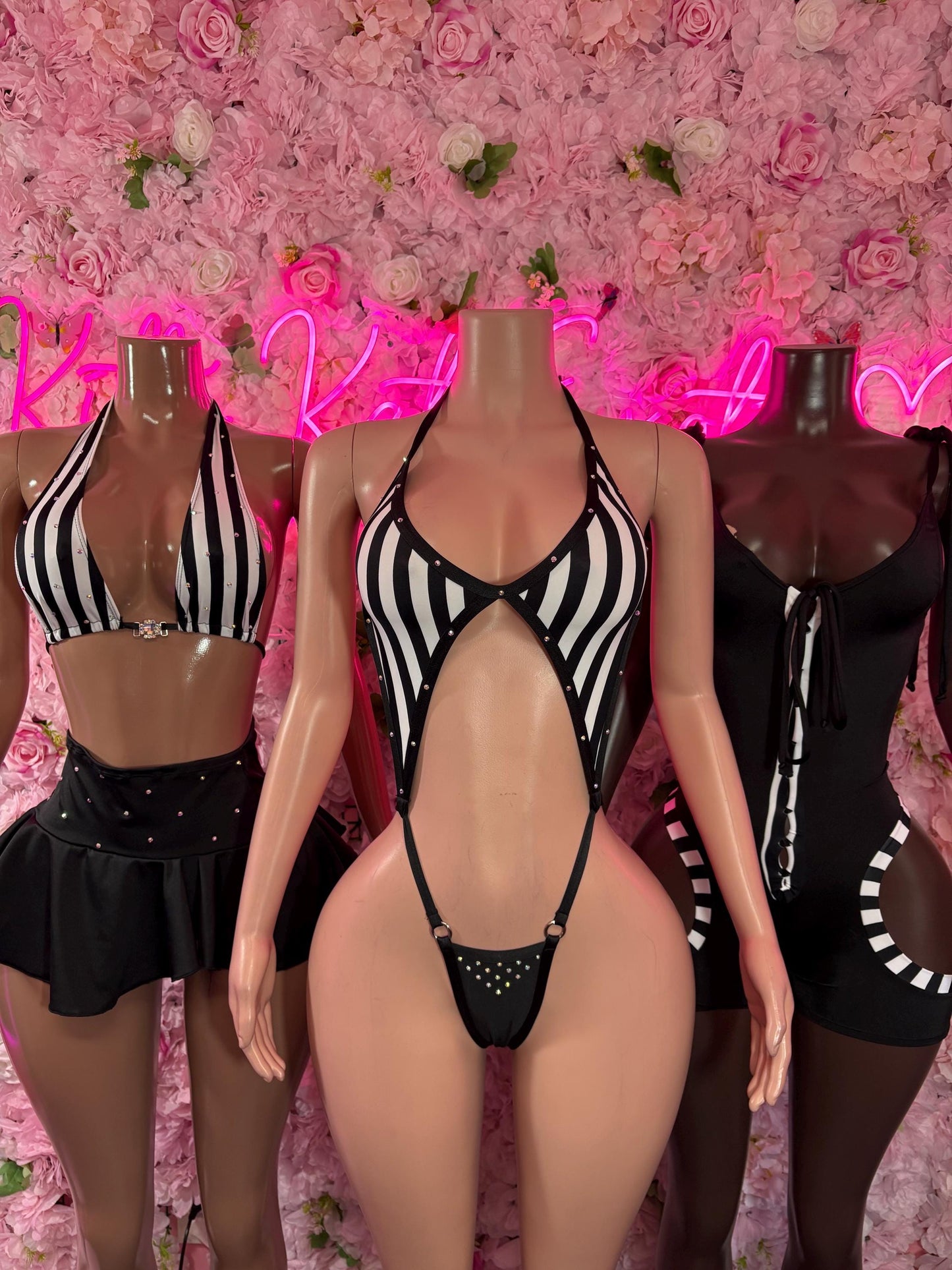 Black striped cutout bodysuit with halter neck and bow ties, shown front and back