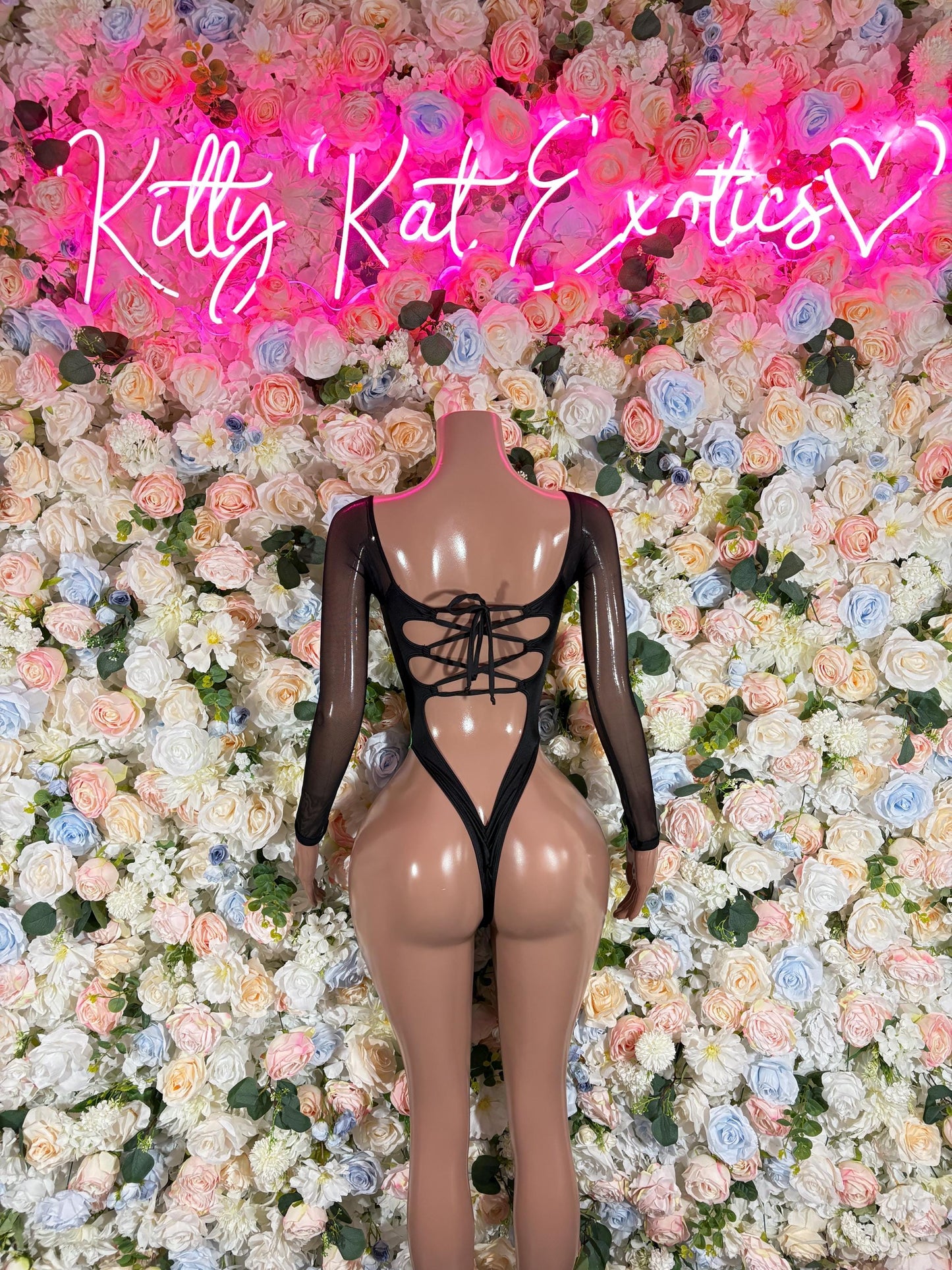 Green electric one-piece bodysuit with long sleeves, crisscross lace under bust