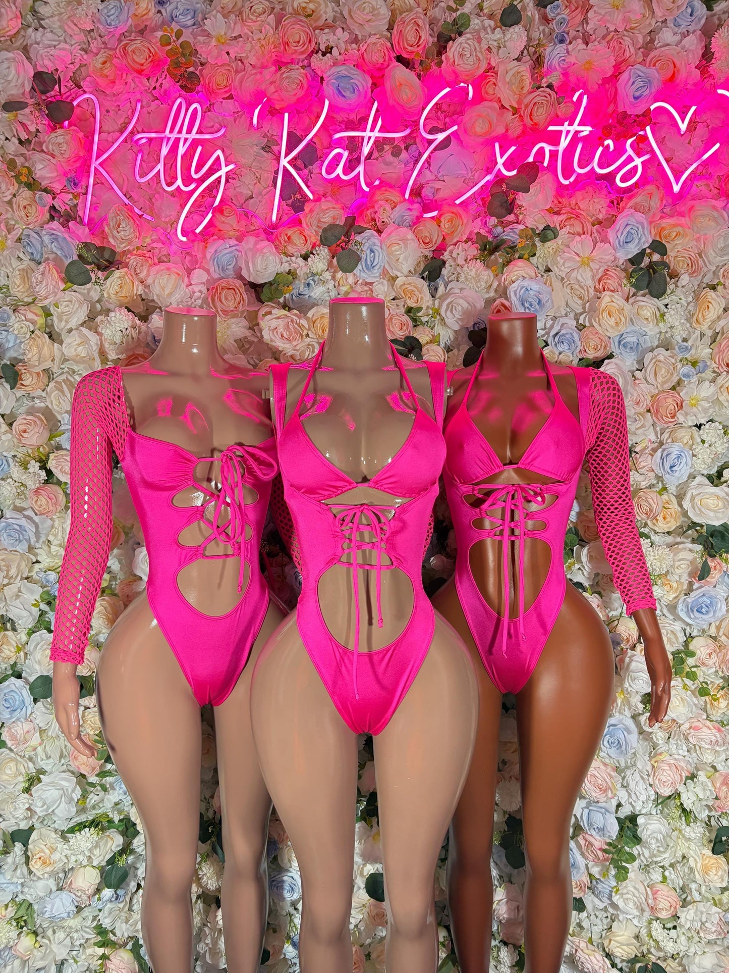 Pink lace-up bodysuit with sheer long sleeves, front cutout and back lacing