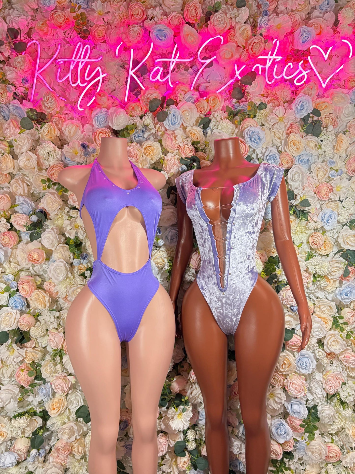 Purple one-piece bodysuit with halter neckline, open back, and high-cut leg openings
