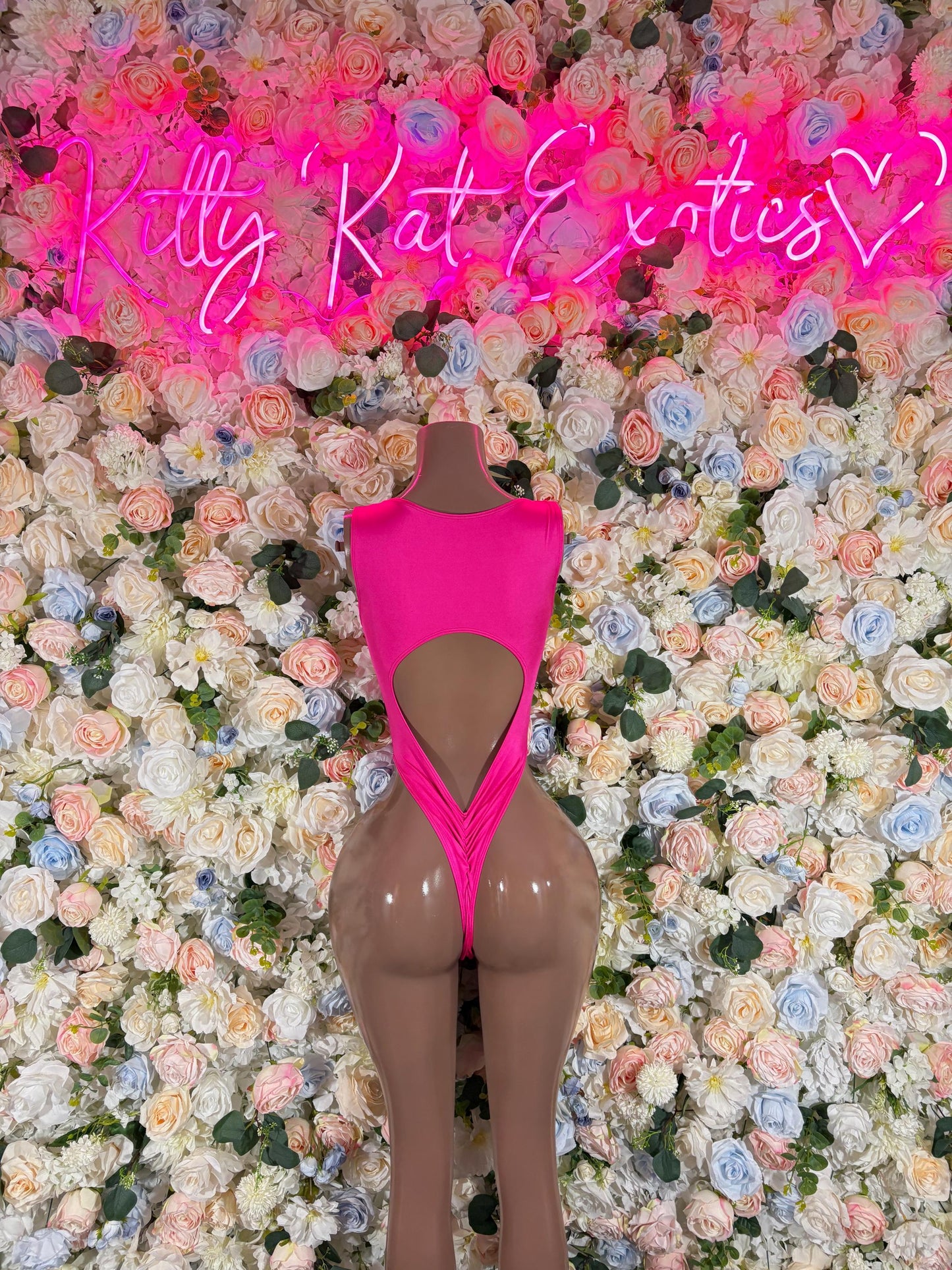 Pink one-piece bodysuit with V-shaped back and cheeky coverage