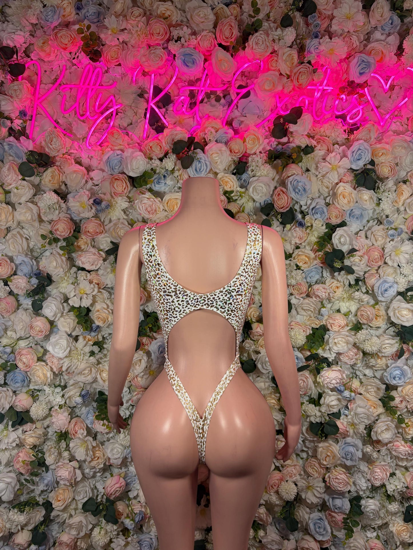 Cheetah-print open-back bodysuit with crisscross straps and cheeky coverage