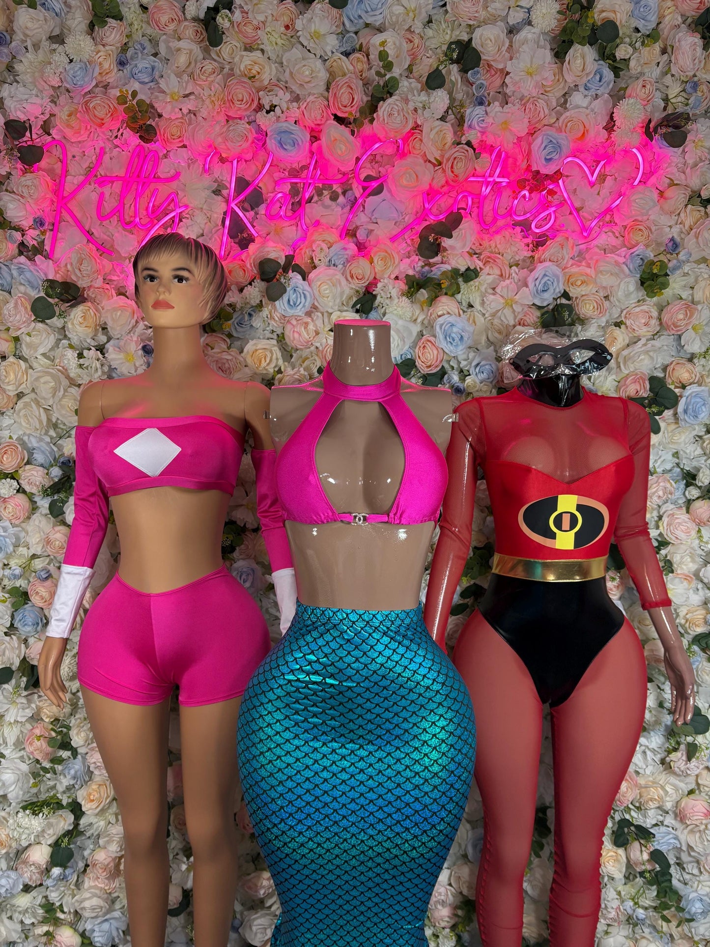 Three cosplay outfits: pink crop top and shorts, teal fishnet mermaid dress, red suit