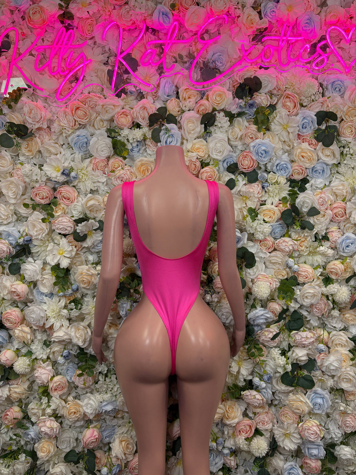 Hot pink lace-up plunge bodysuit with open back and halter straps