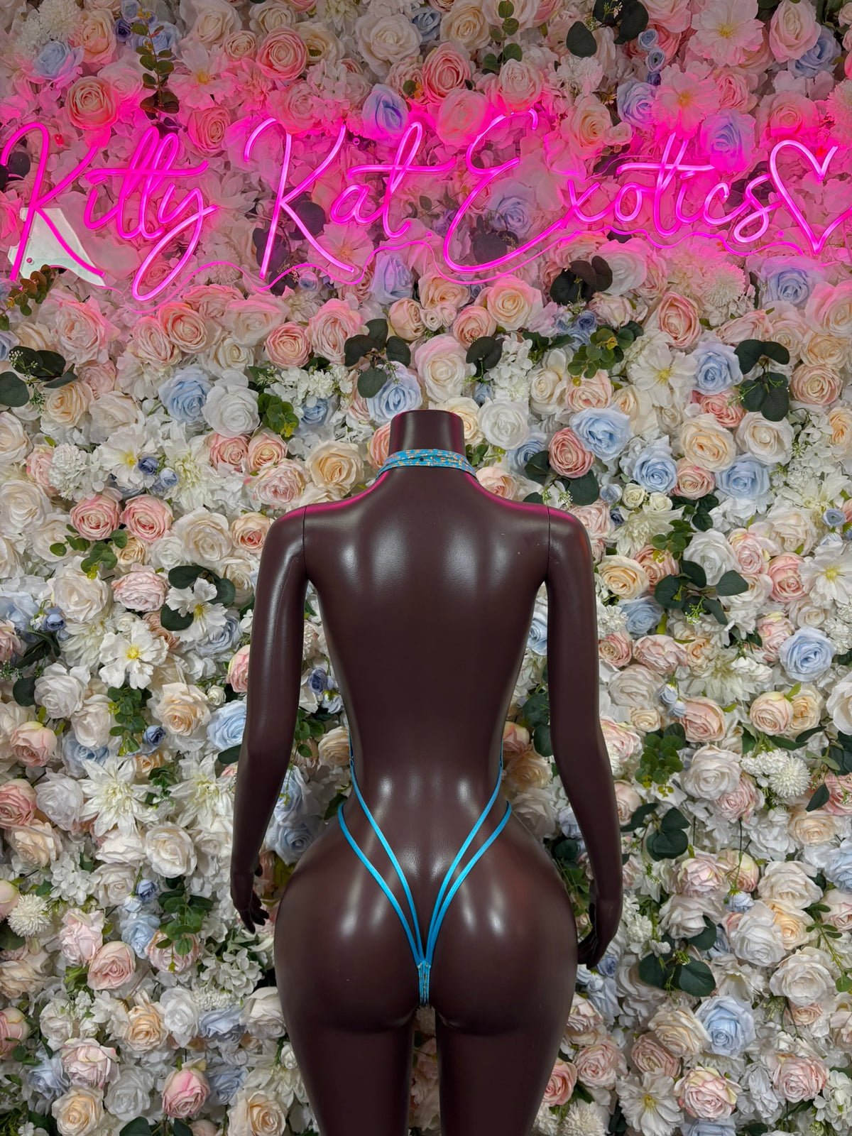 Aqua cheetah-print one-piece bodysuit with thin blue straps, back view