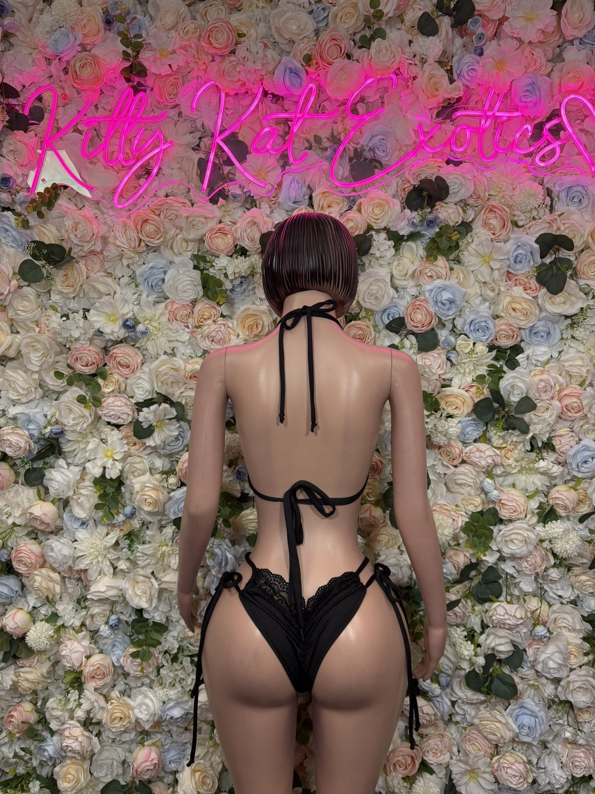 Black lace lingerie set, tie-back triangle bra and matching thong, back view