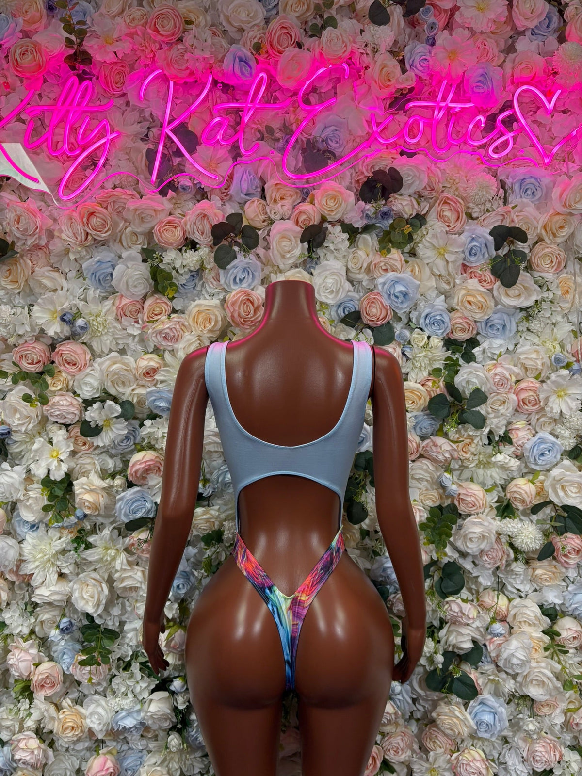 Light blue one-piece swimsuit with multicolor panel, open back and thin straps