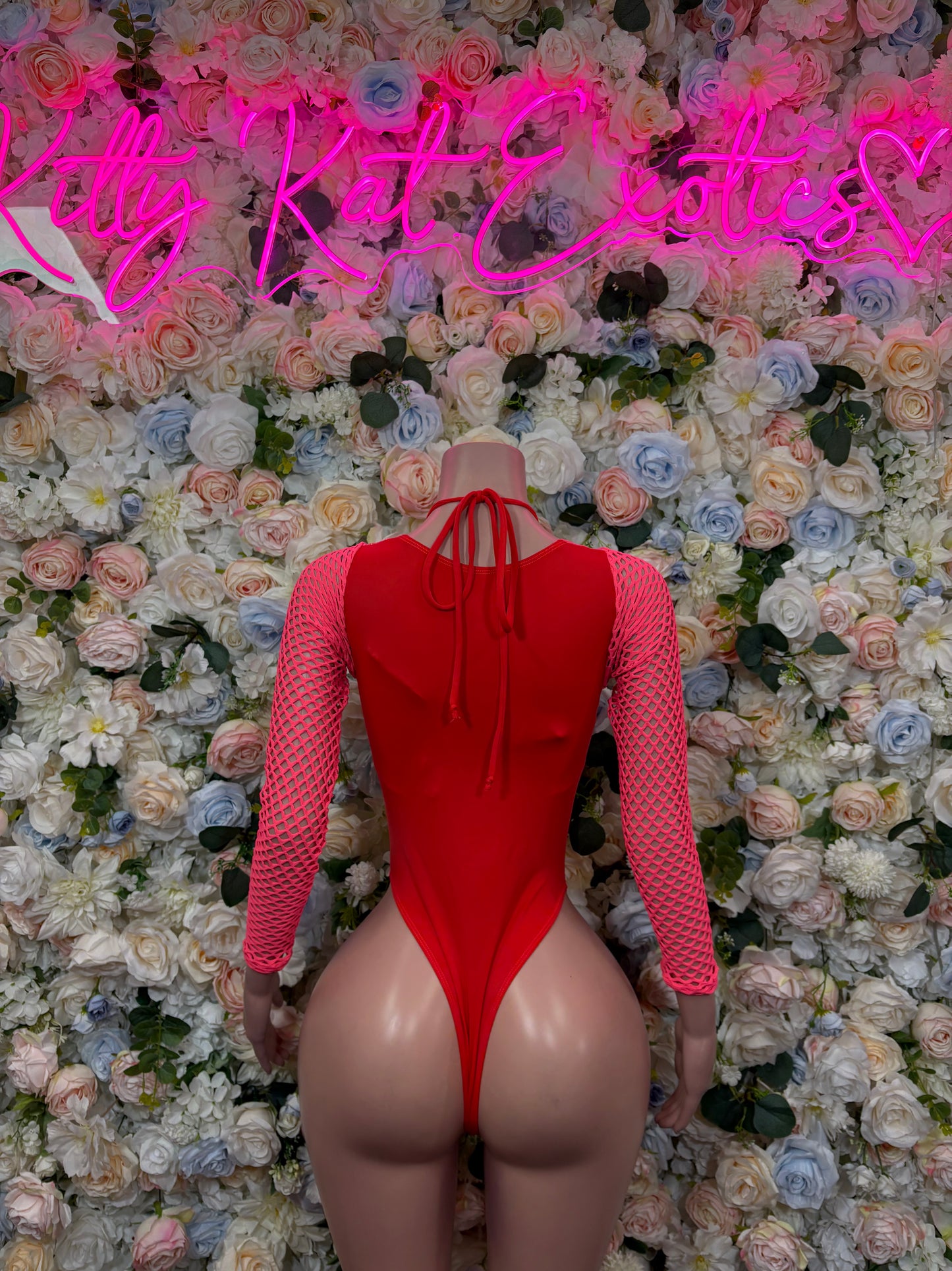 Pink metallic bodysuit with long sleeves and crisscross back lace-up