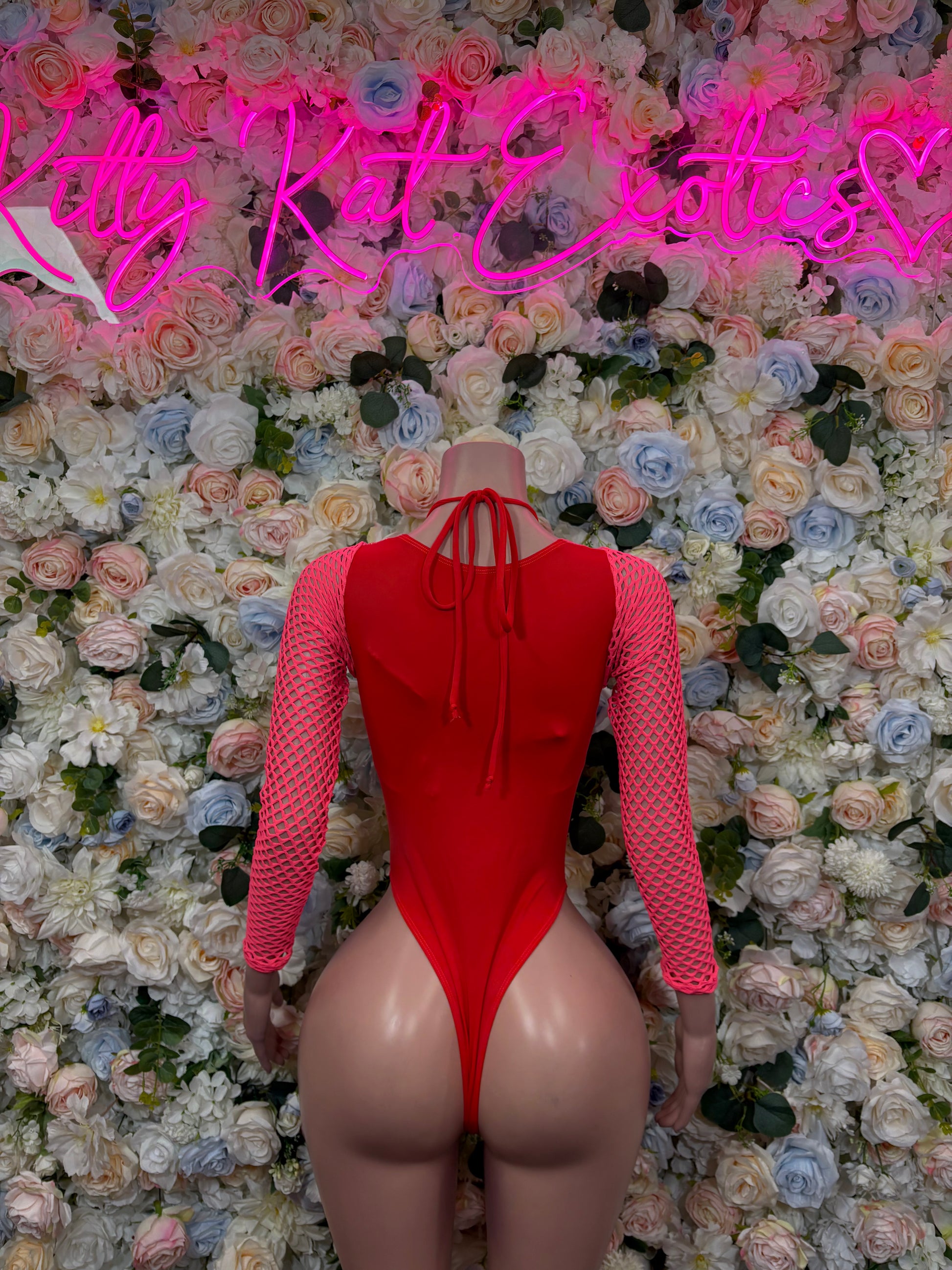 Pink metallic bodysuit with long sleeves and crisscross back lace-up