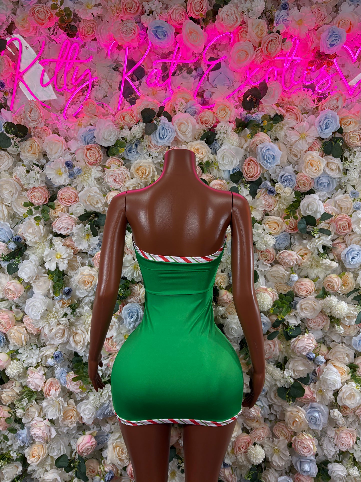 Green bodycon mini dress with red-and-white striped low back