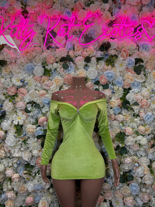 Lime green long-sleeve mini dress on mannequin, ruched bow bust, fitted waist.