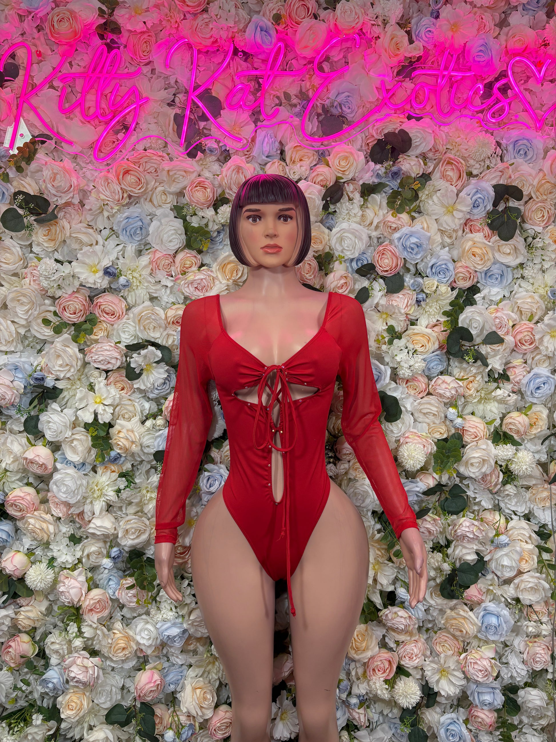 Red long-sleeve bodysuit with lace-up front bow and high-cut leg openings