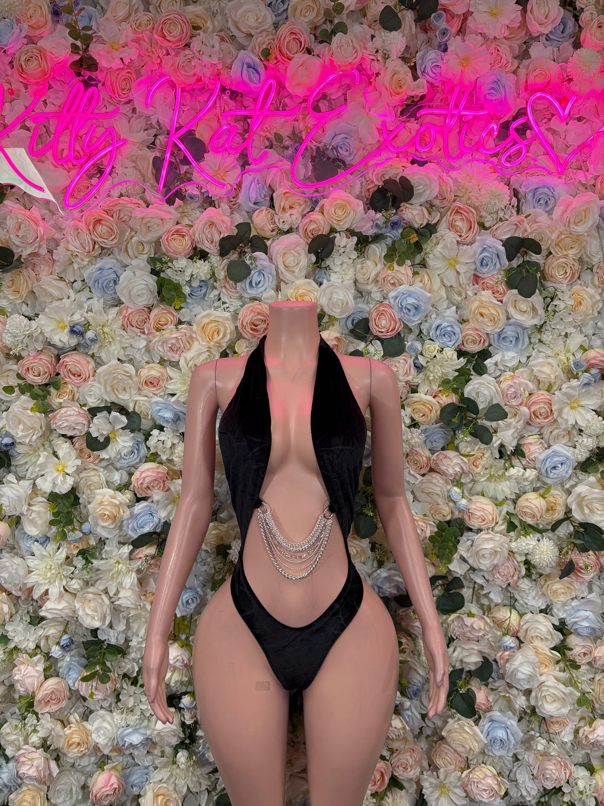 Black velvet slingshot bodysuit with deep V front, thong bottom, chain trim details