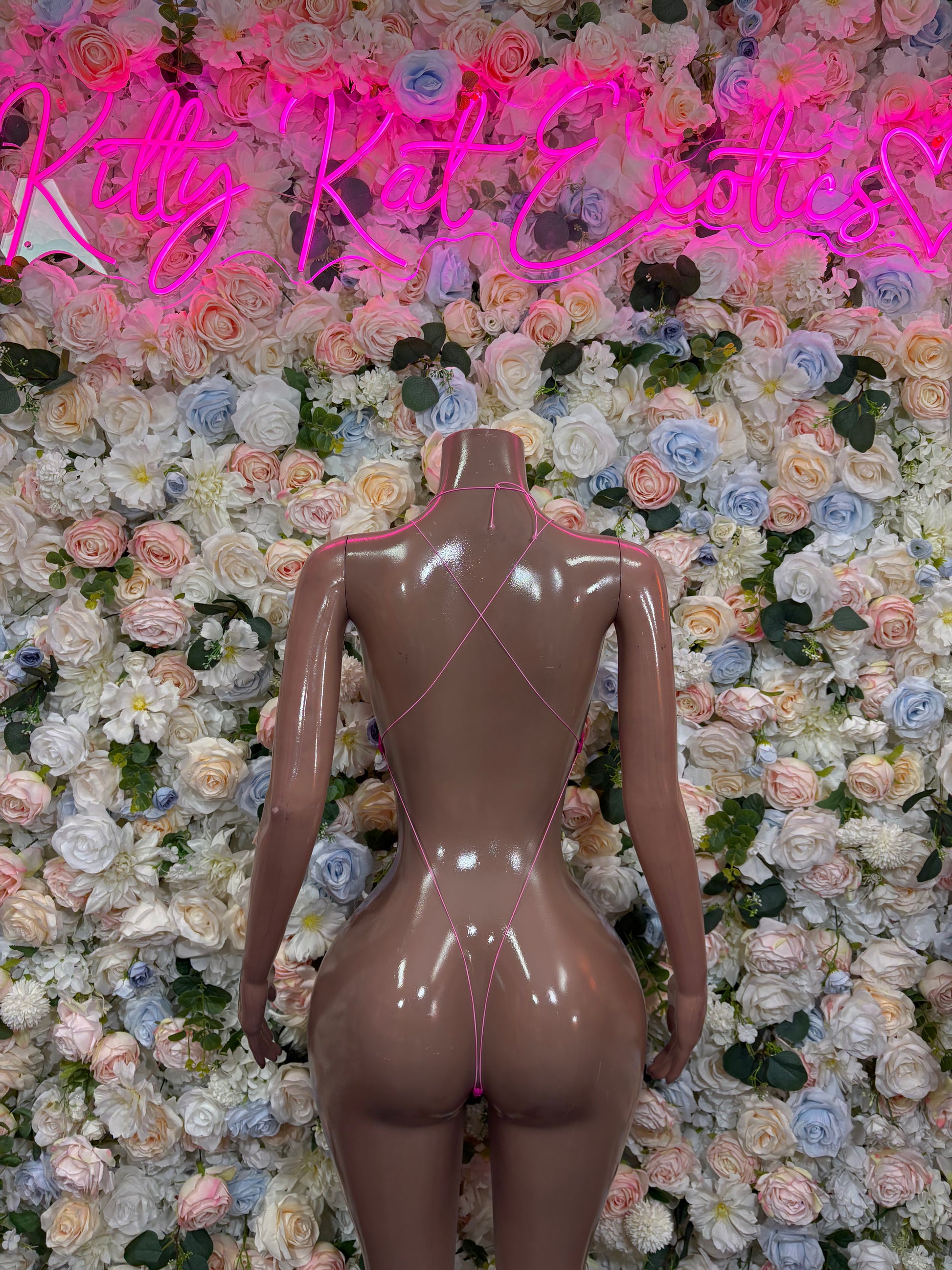 Pink one-piece bodysuit back view, low scoop back, high-cut legs, rhinestone accents