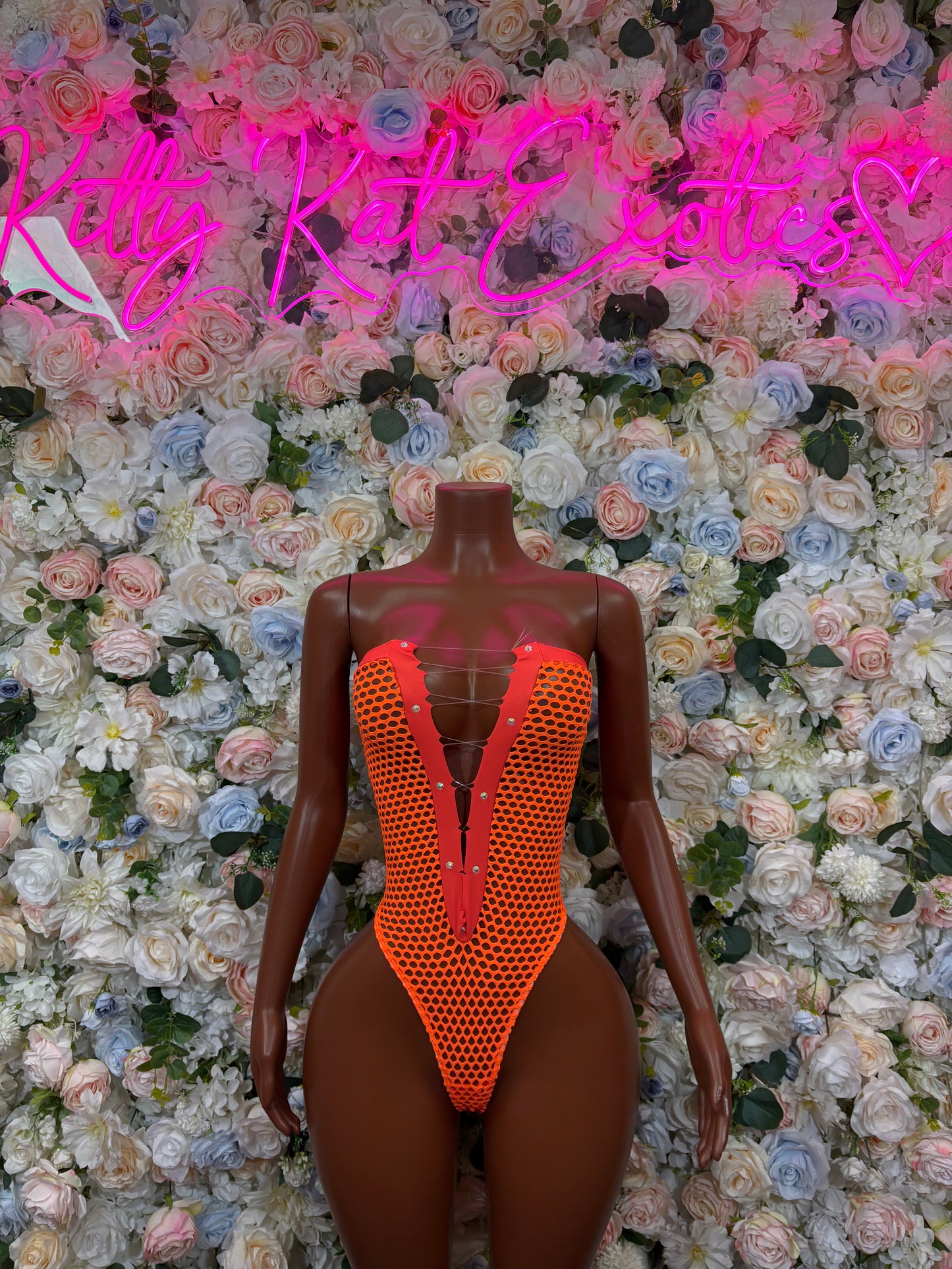 Orange mesh one-piece bodysuit with deep V front and open back