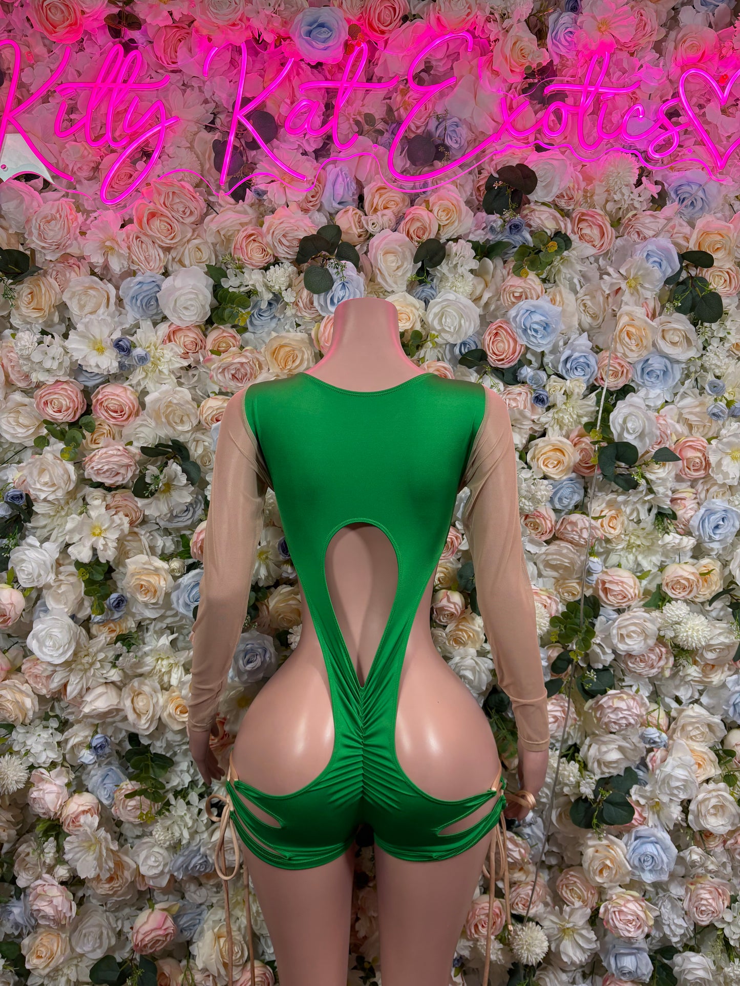 Green one-piece bodysuit with long sheer sleeves and large back cutout panel