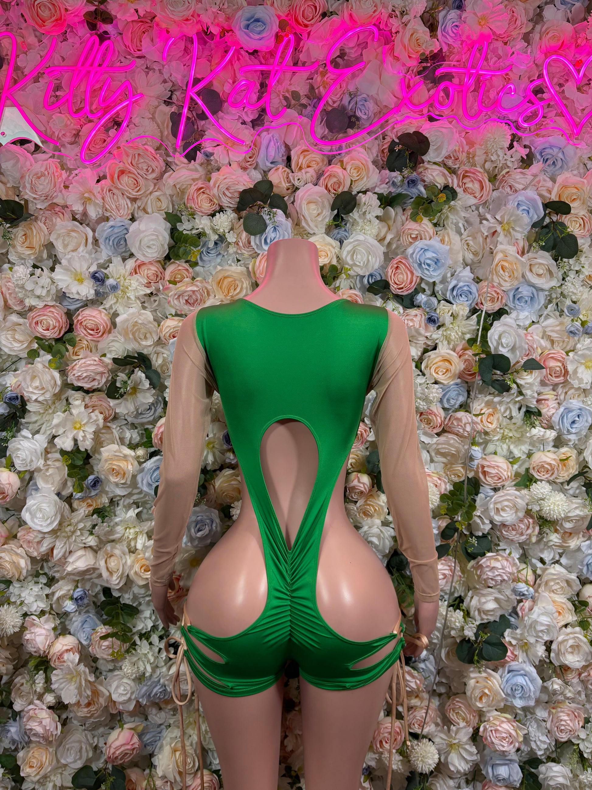 Green one-piece bodysuit with long sheer sleeves and large back cutout panel