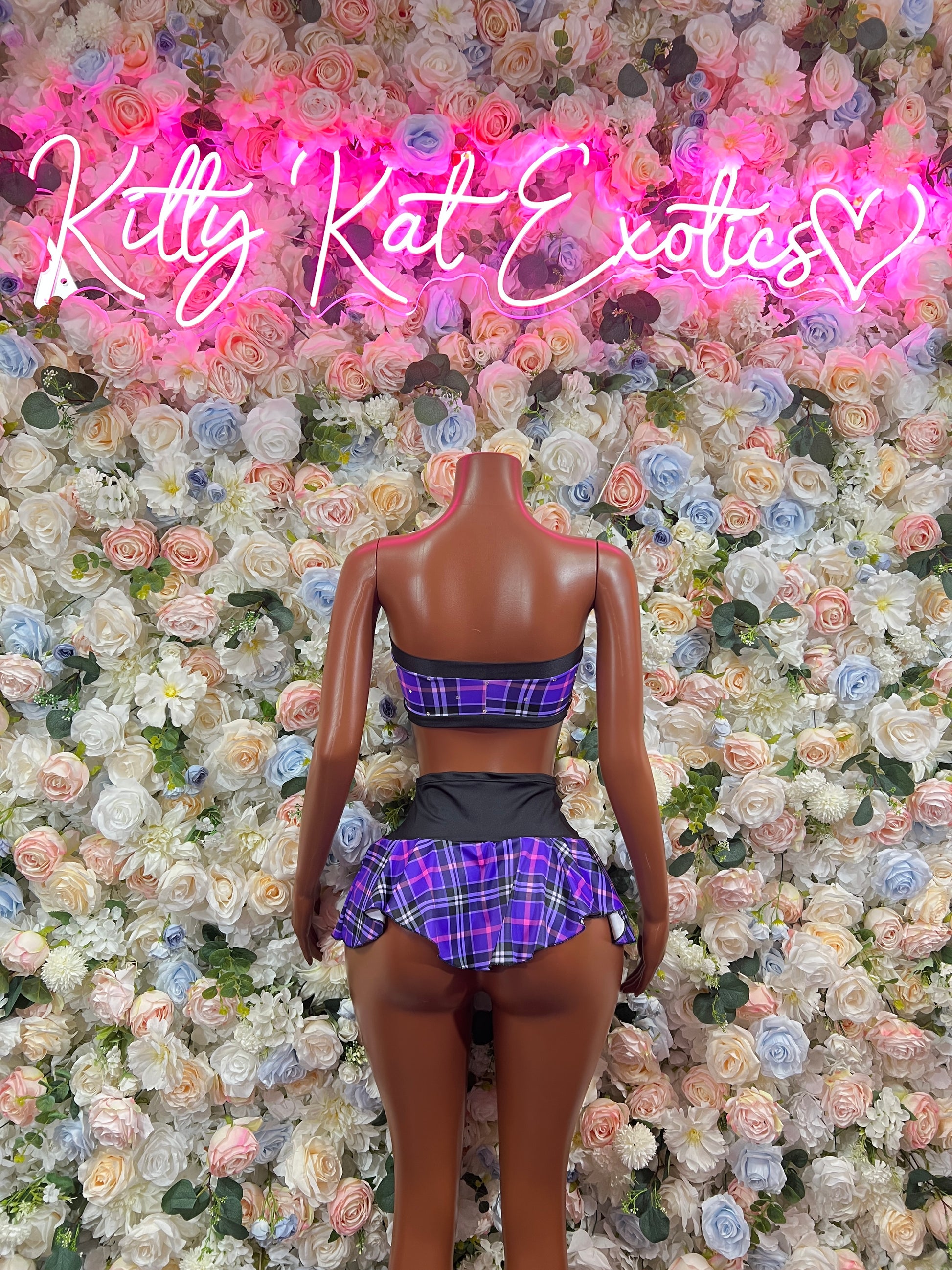 Back view of purple plaid bandeau top and matching mini skirt set with black trim