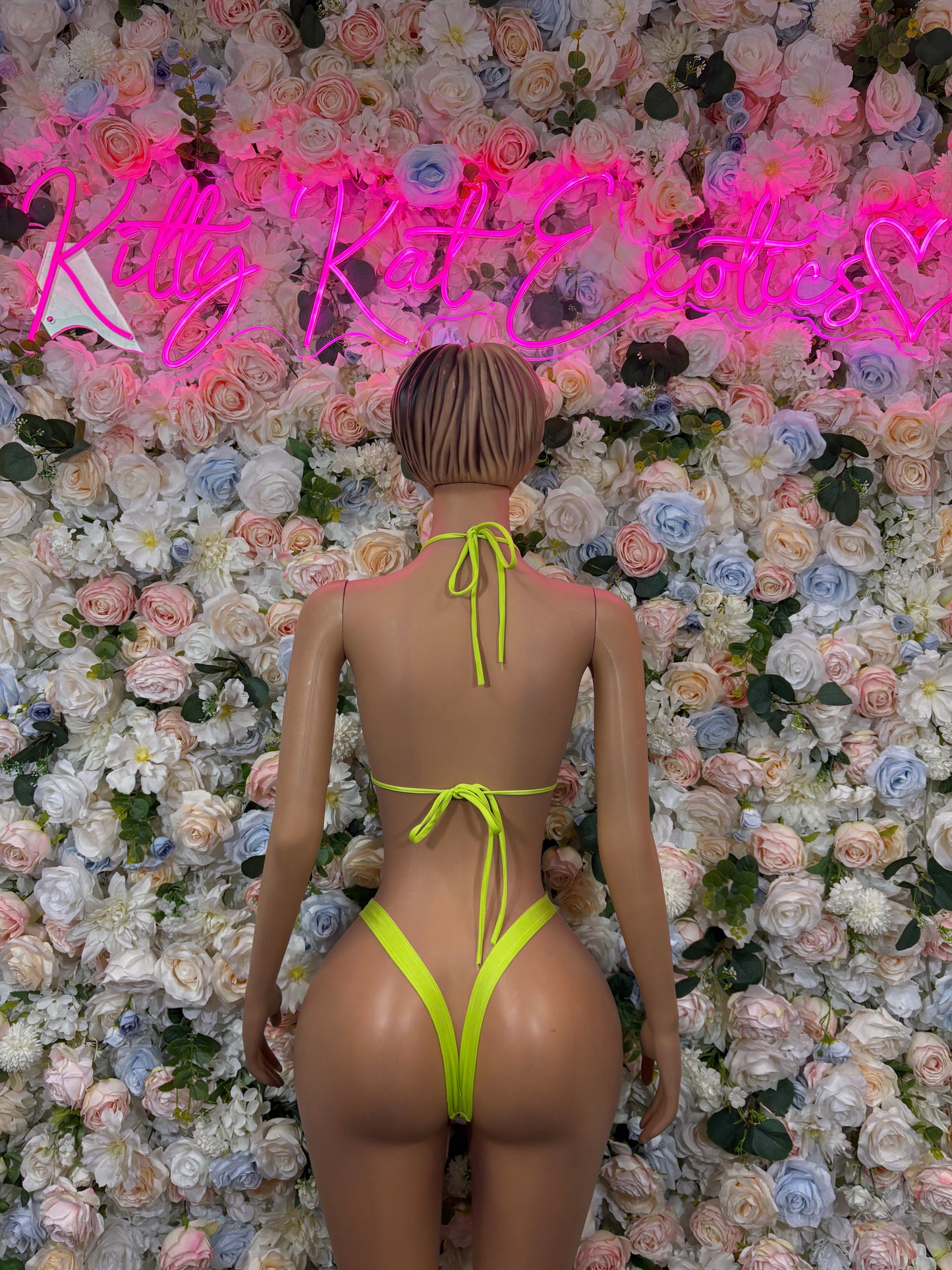 Neon green two-piece bikini set with halter tie-back and string high-cut bottoms