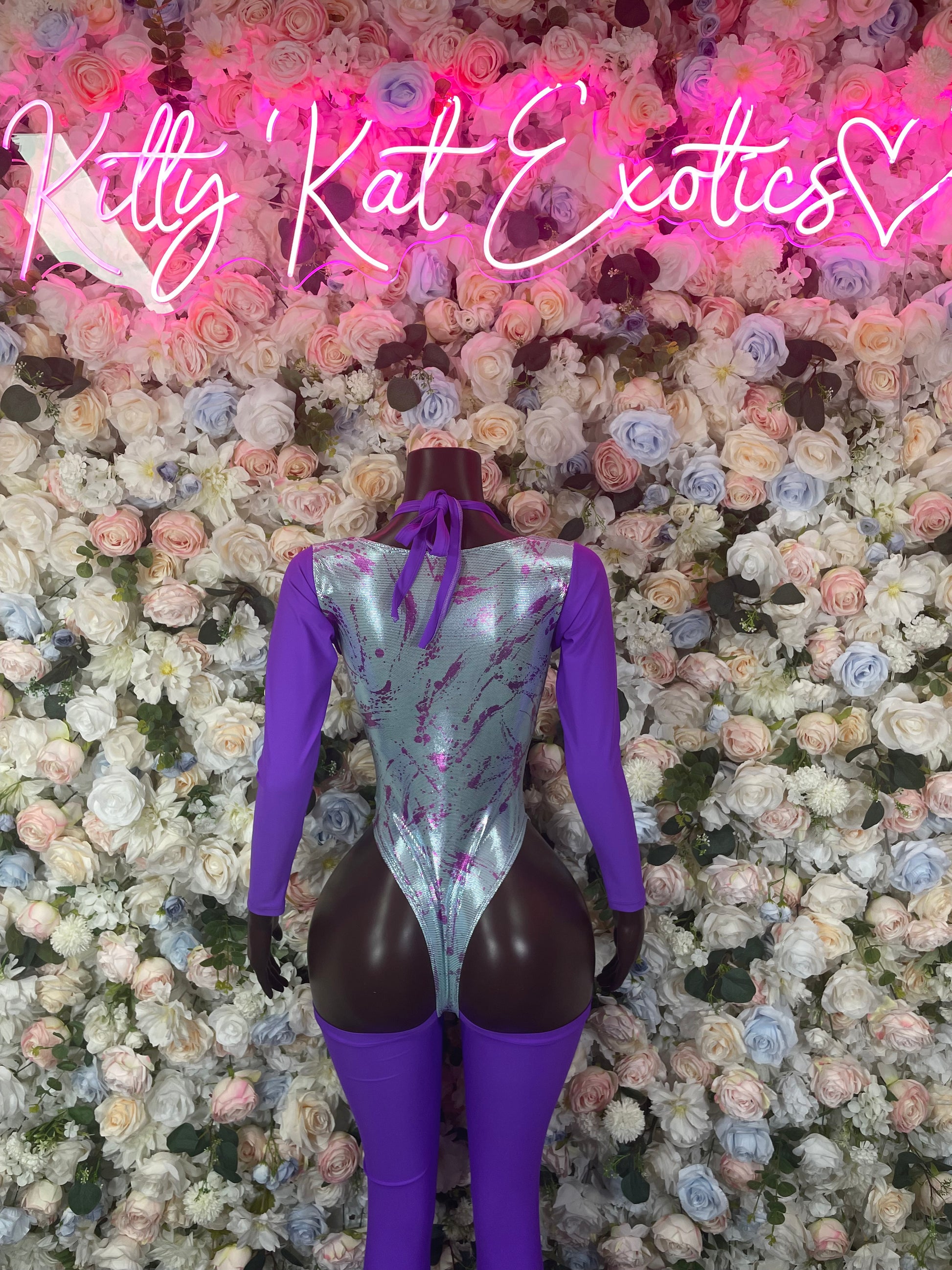 Purple one-piece bodysuit with long sleeves and lace-up back