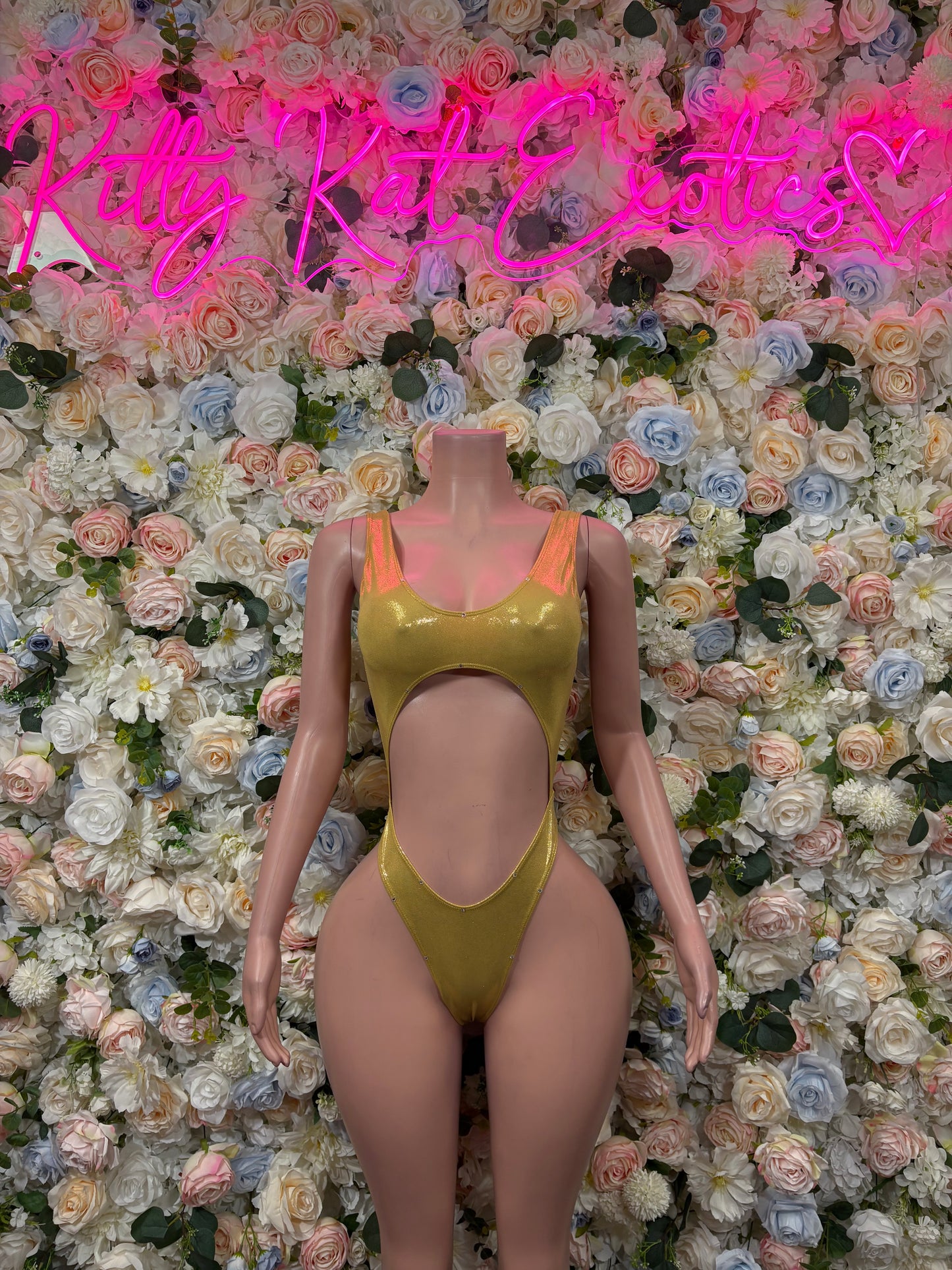 Gold one-piece bodysuit with scoop neckline and high-cut leg openings