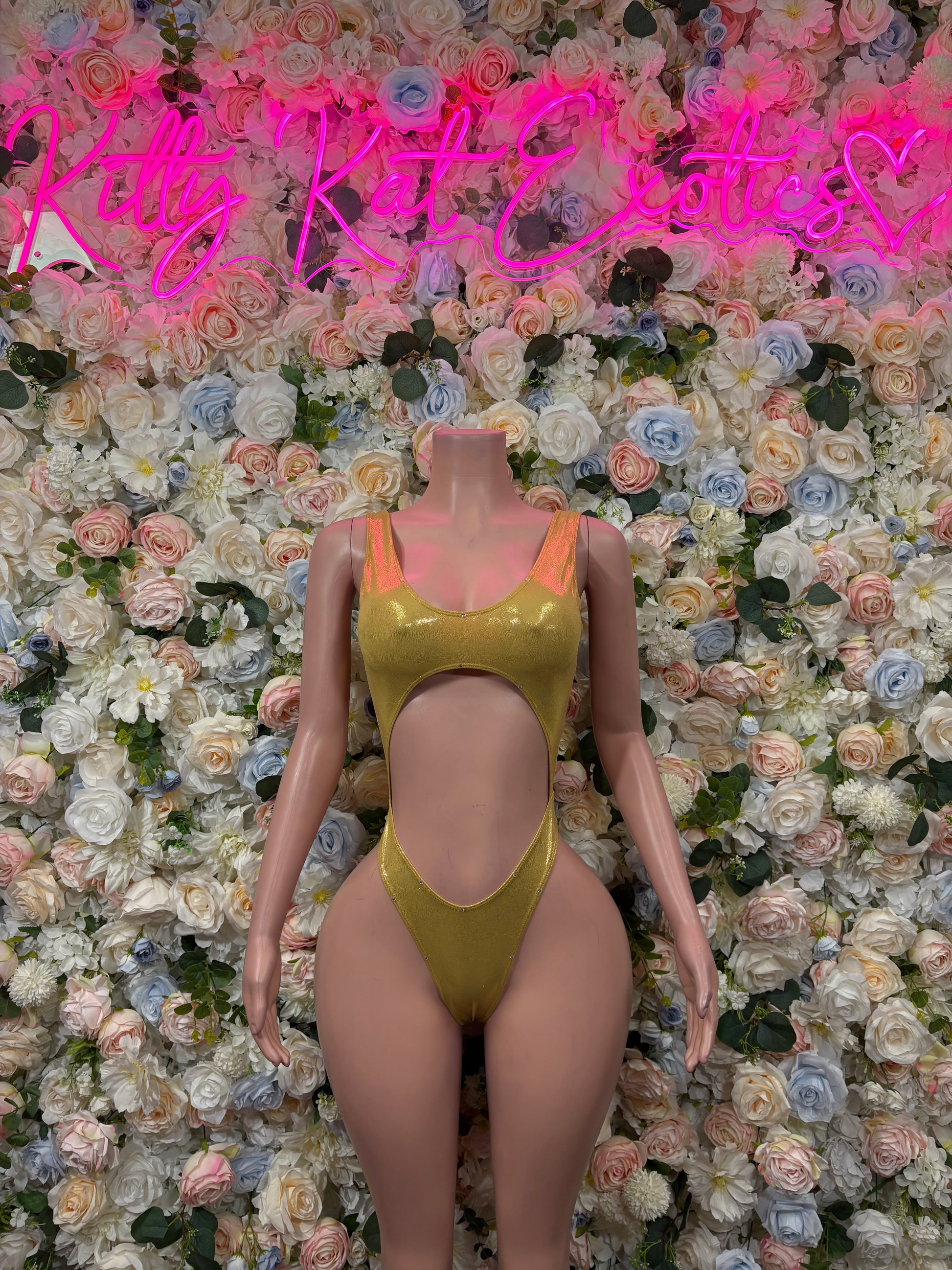 Gold one-piece bodysuit with scoop neckline and high-cut leg openings