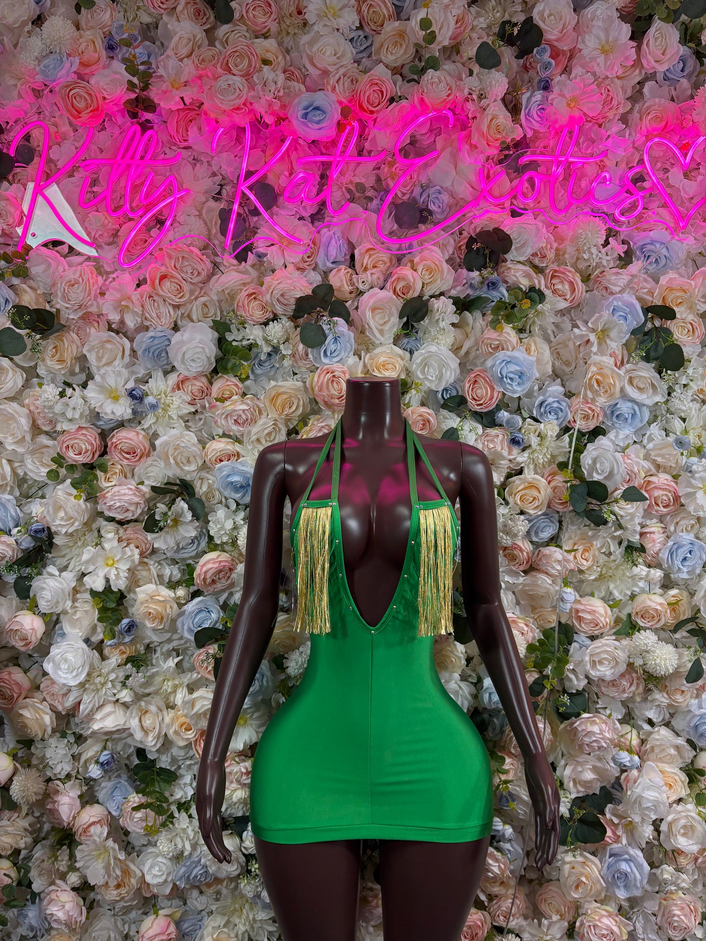 Green v-neck festival bodysuit dress with long tassel trim and open-back cut