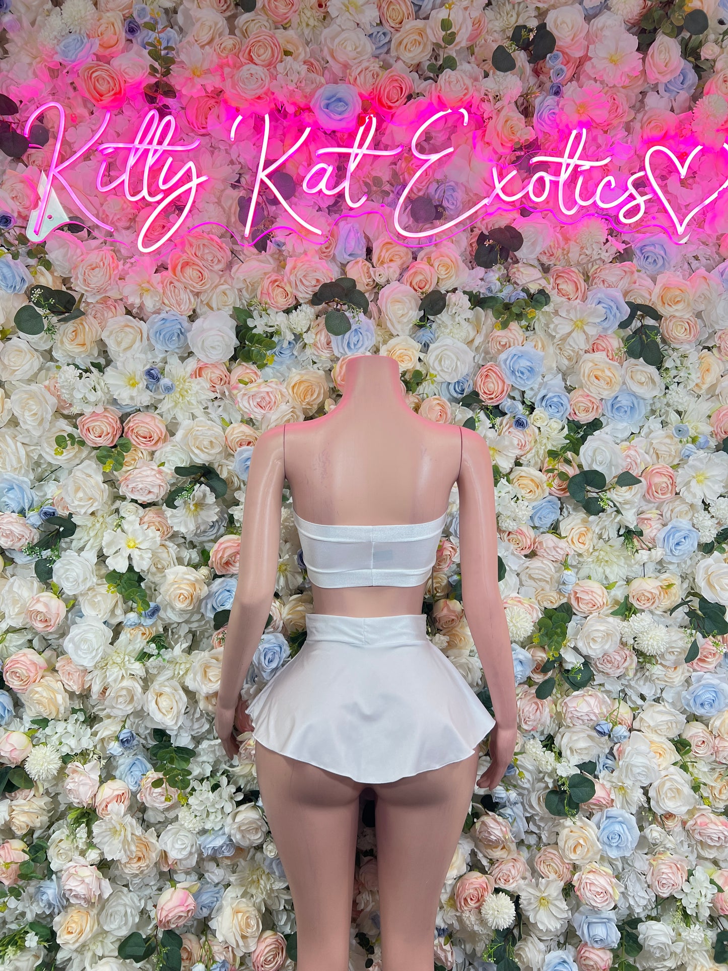 White two-piece rave outfit: open-back bandeau top with ruffled mini skirt