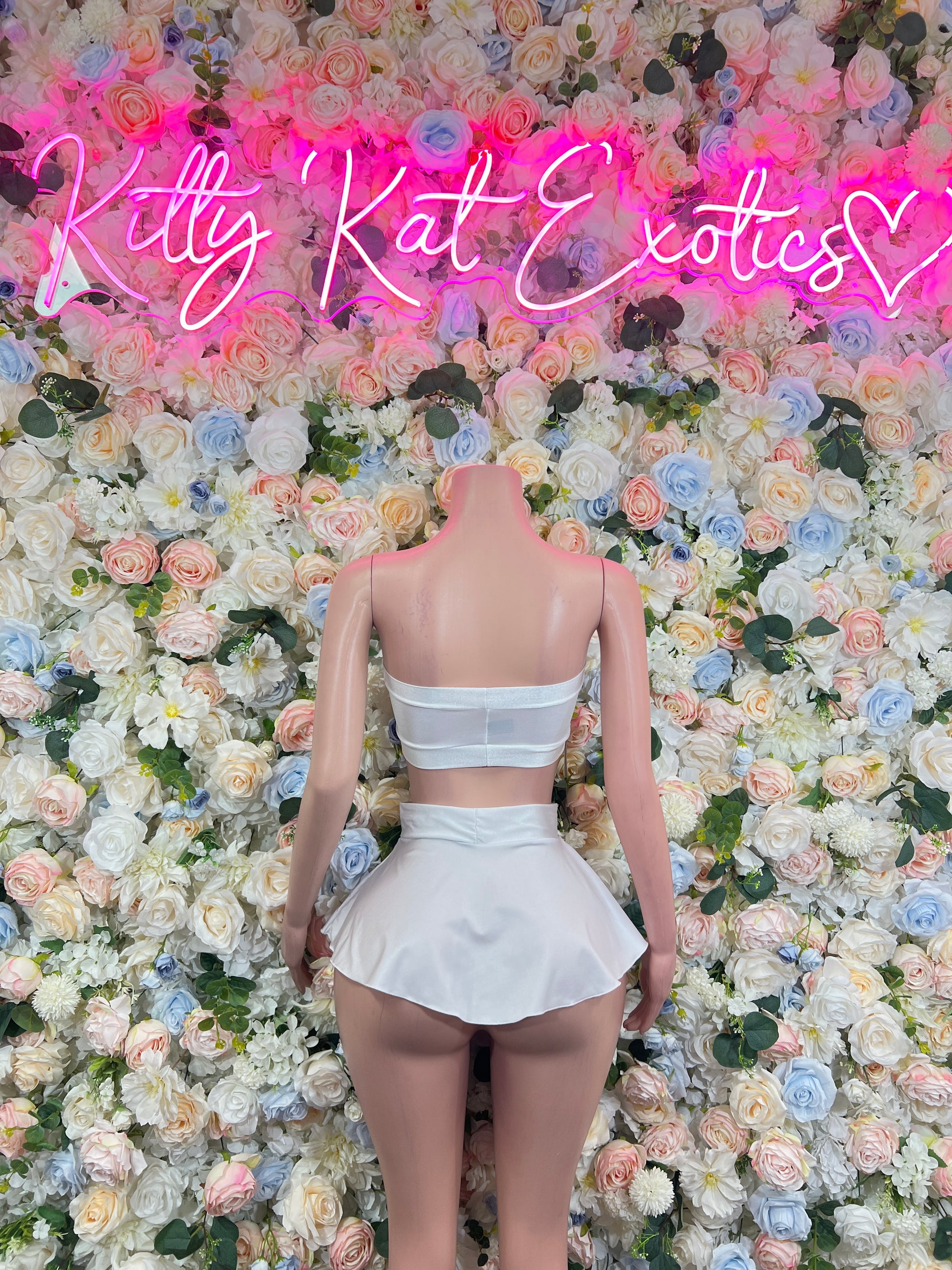 White two-piece rave outfit: open-back bandeau top with ruffled mini skirt