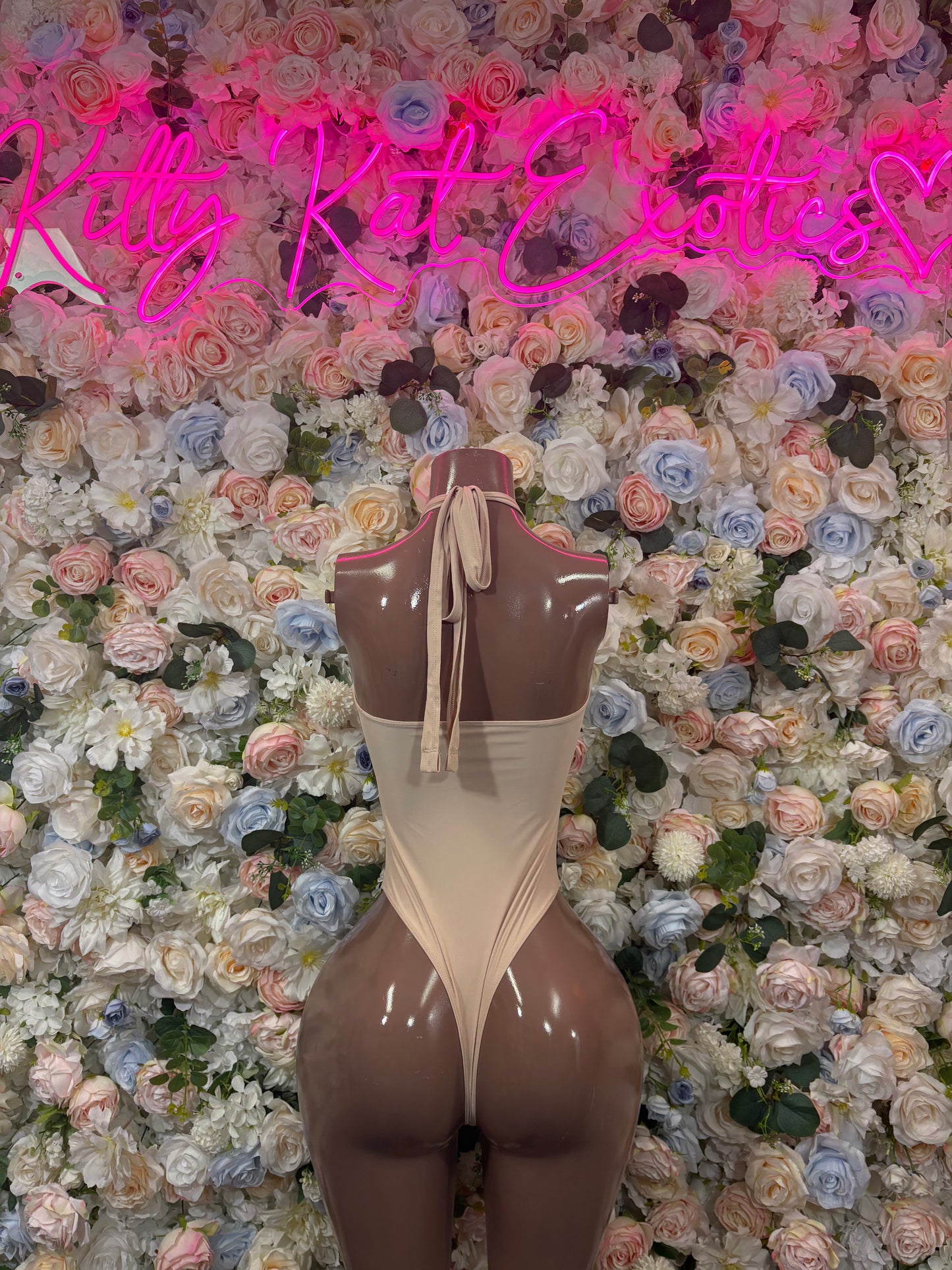 Nude beige high-cut bodysuit with open back and halter-style ties