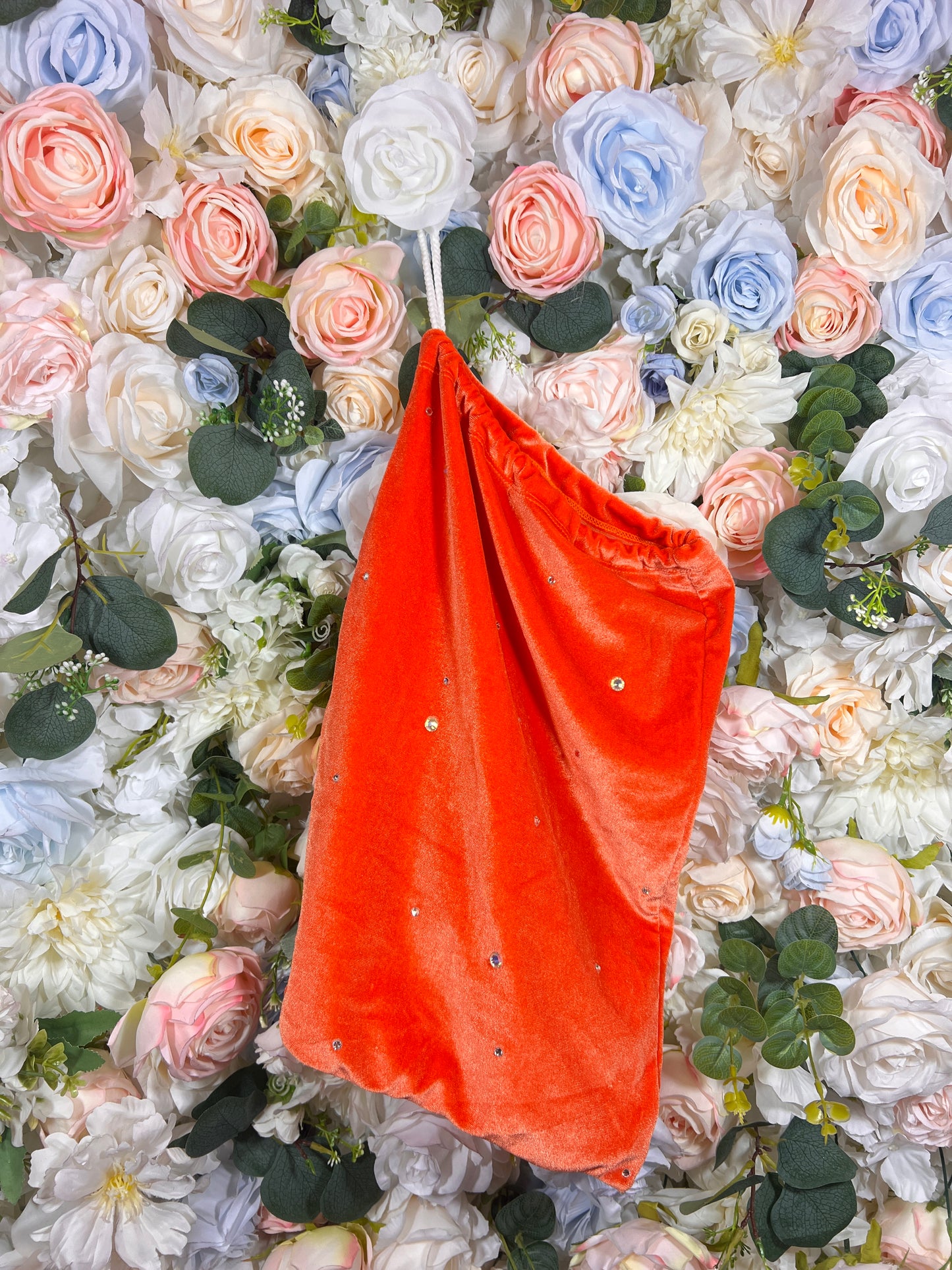 Orange velvet money pouch with drawstring opening and small bead embellishments