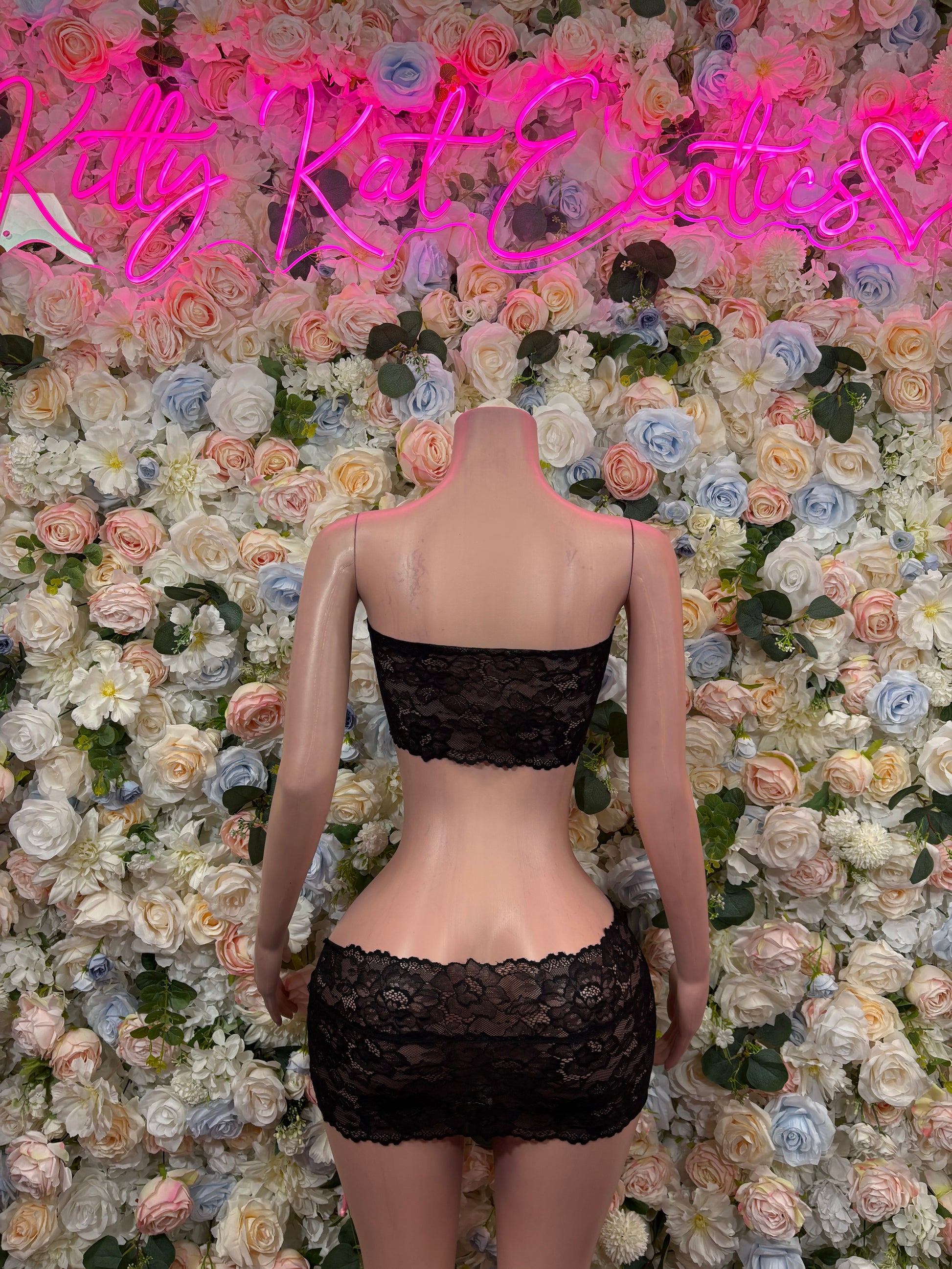 Black lace mini skirt set, back view, with pink ribbon tie detail