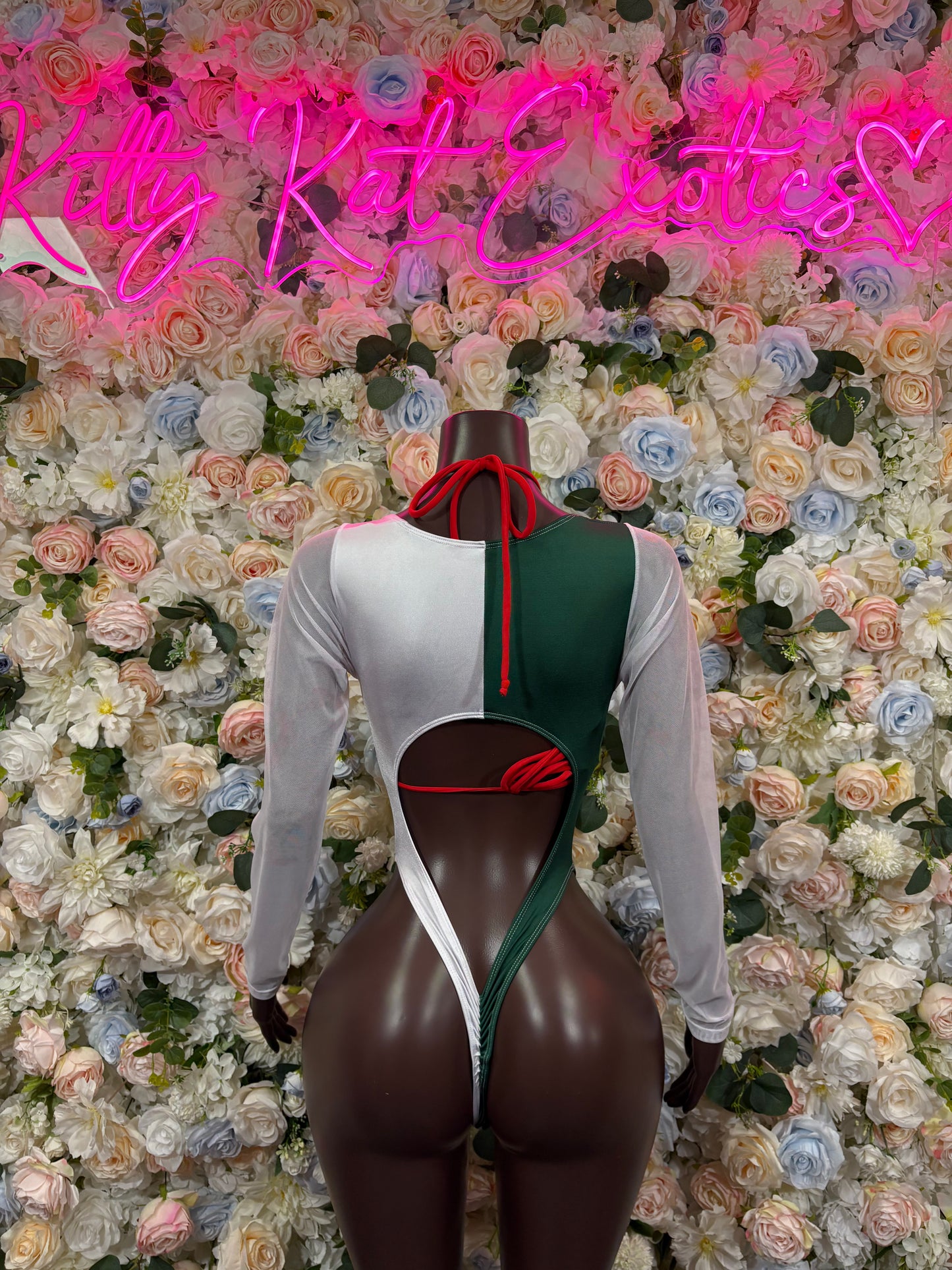 Back of green, white, and red tie-dye bodysuit with red lace-up back strap