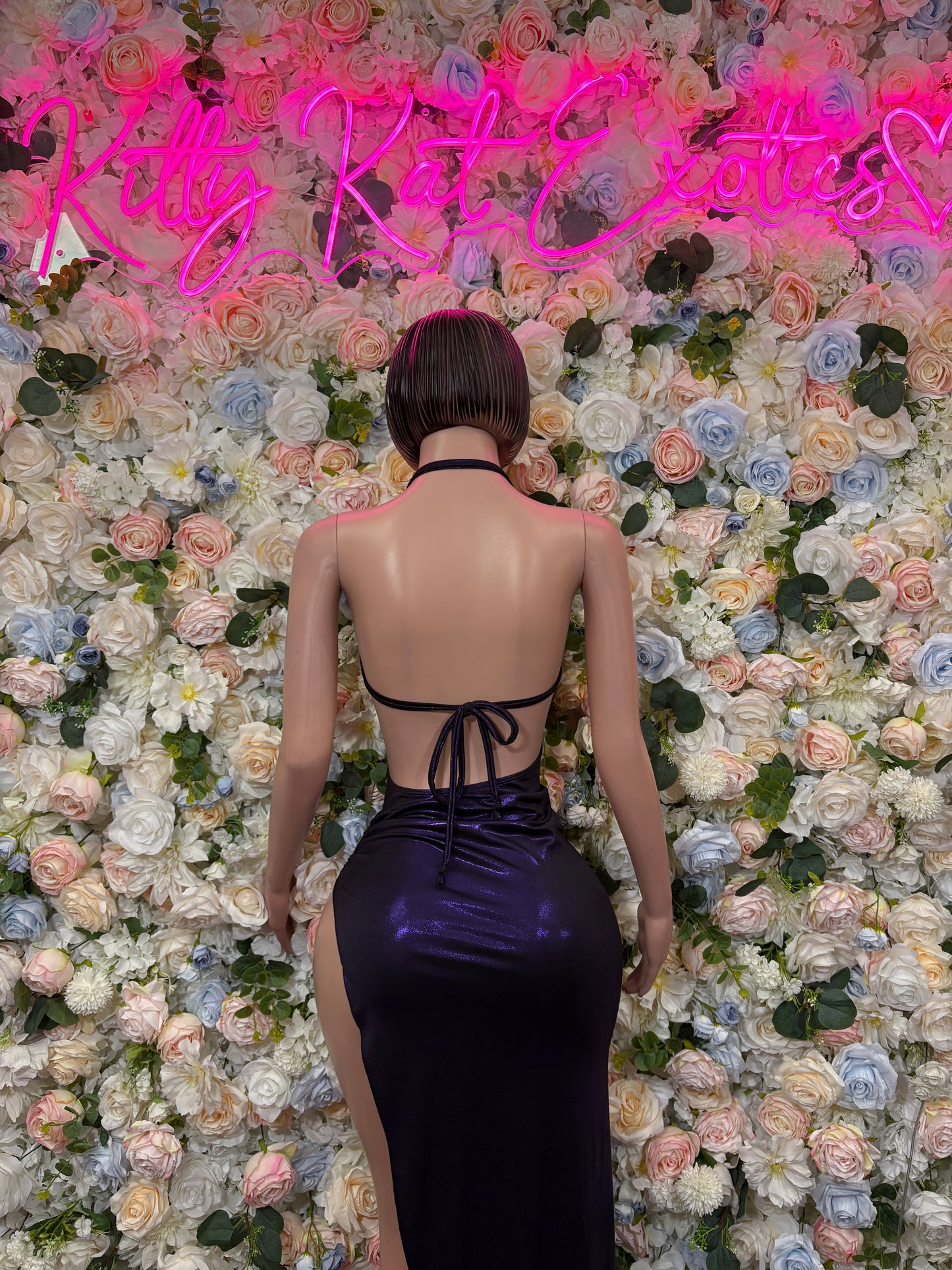 Back view of metallic purple halter gown with crisscross tie and open back