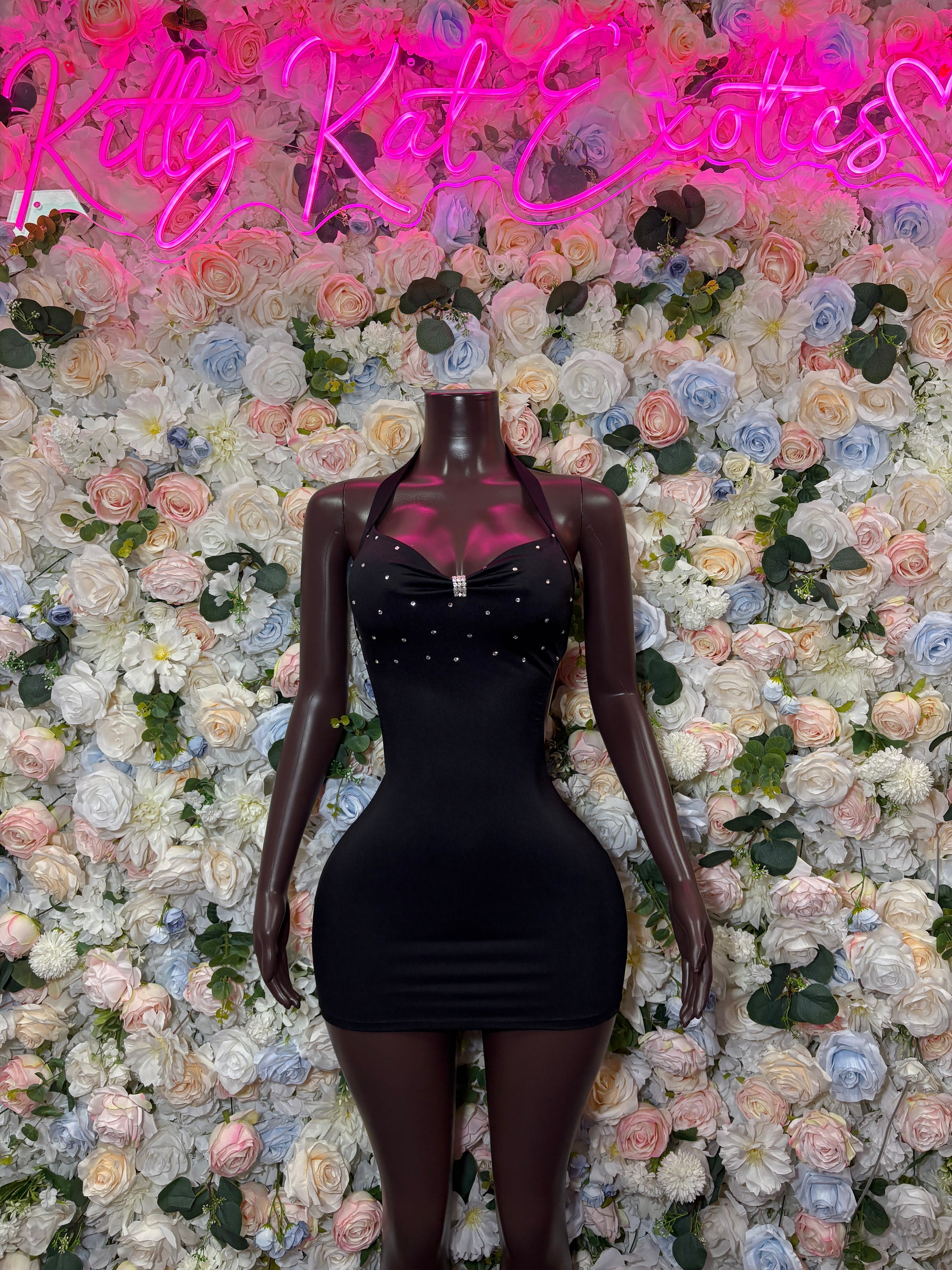 Black ruched mini club dress with V-neck and halter straps