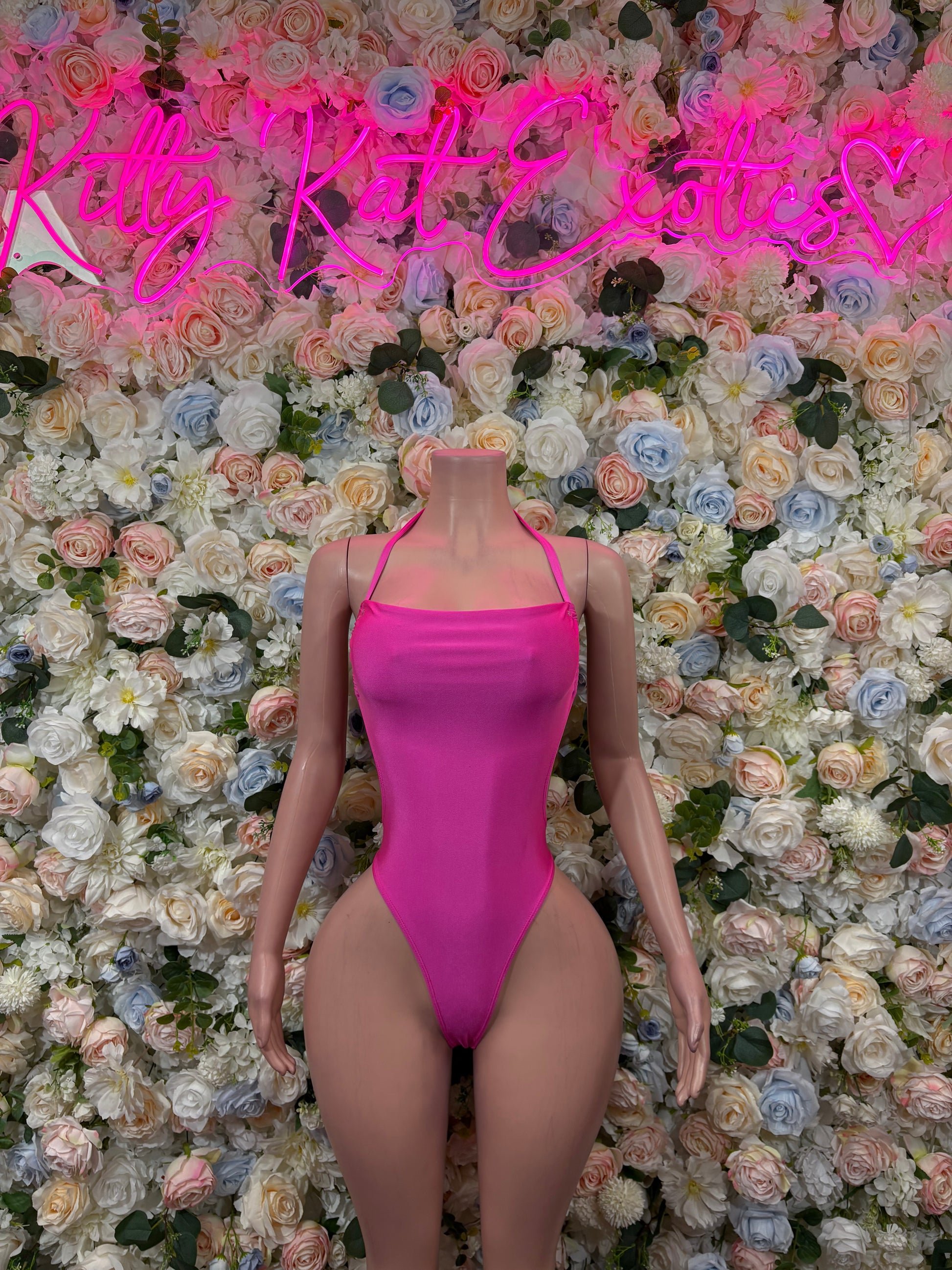 Pink one-piece bodysuit with wide straps and square neckline