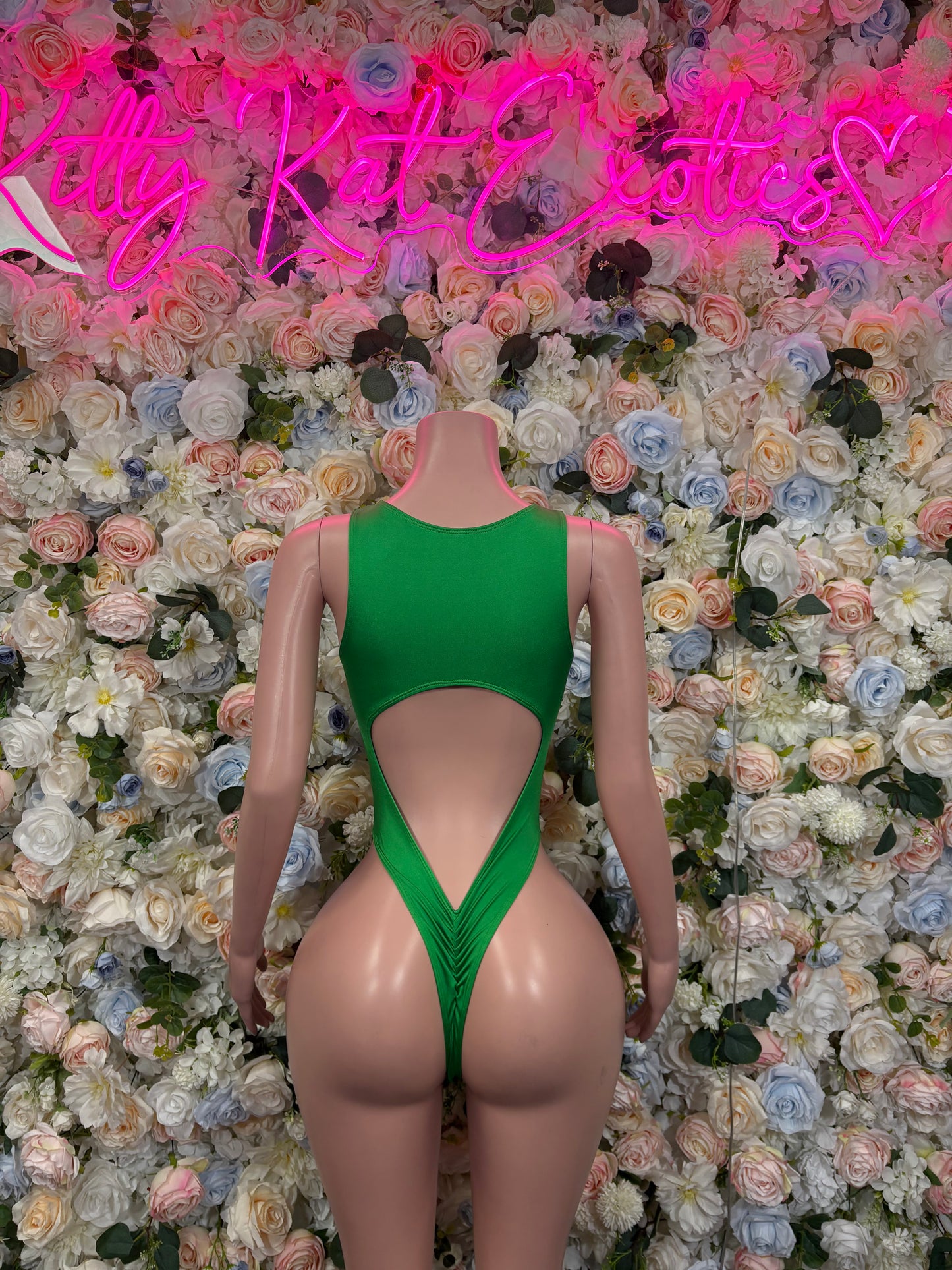 Green bodysuit with crisscross lace-up front cutout and deep V back
