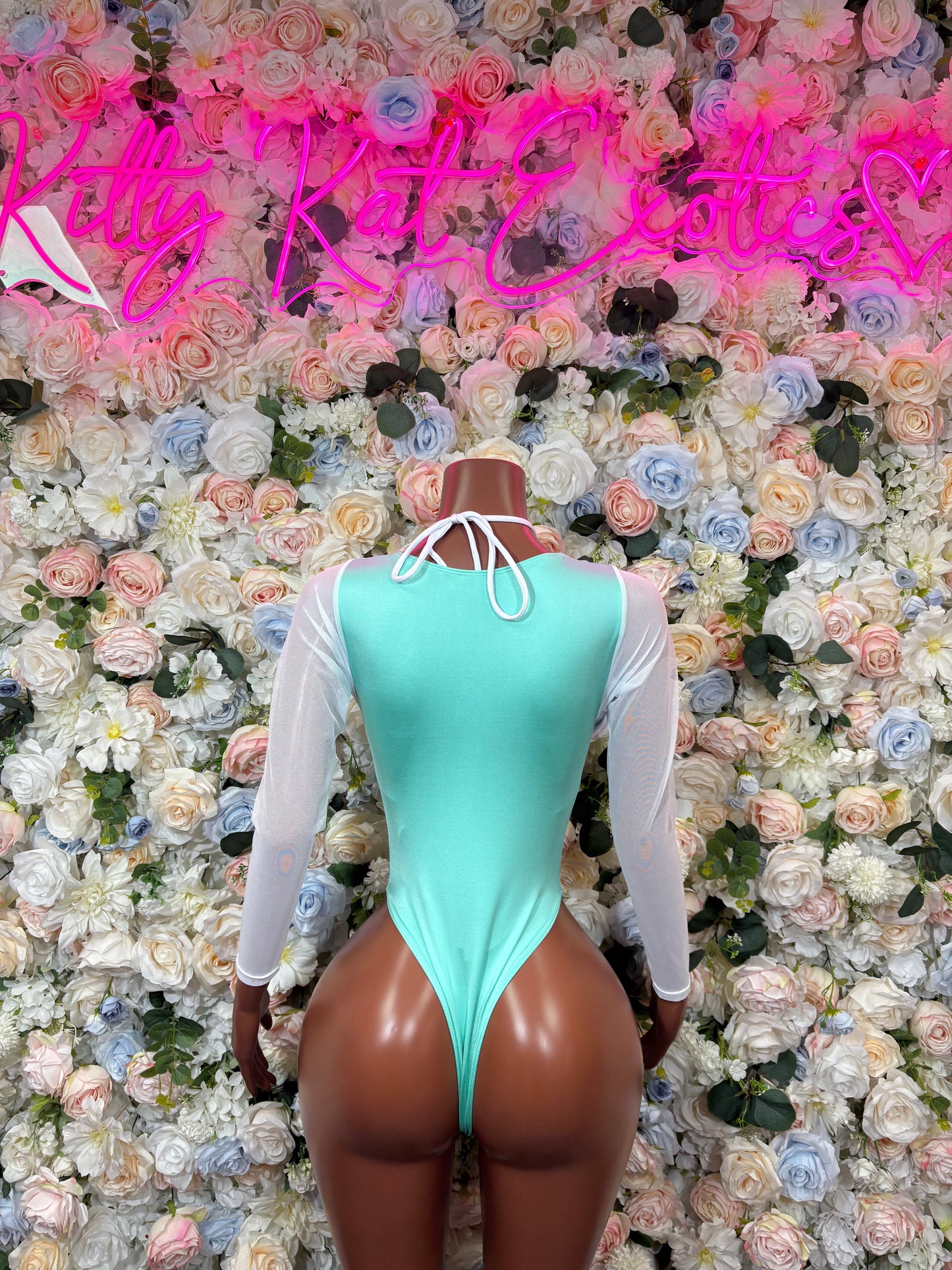 Backless aqua cheetah-print bodysuit with lace-up back and sheer long sleeves